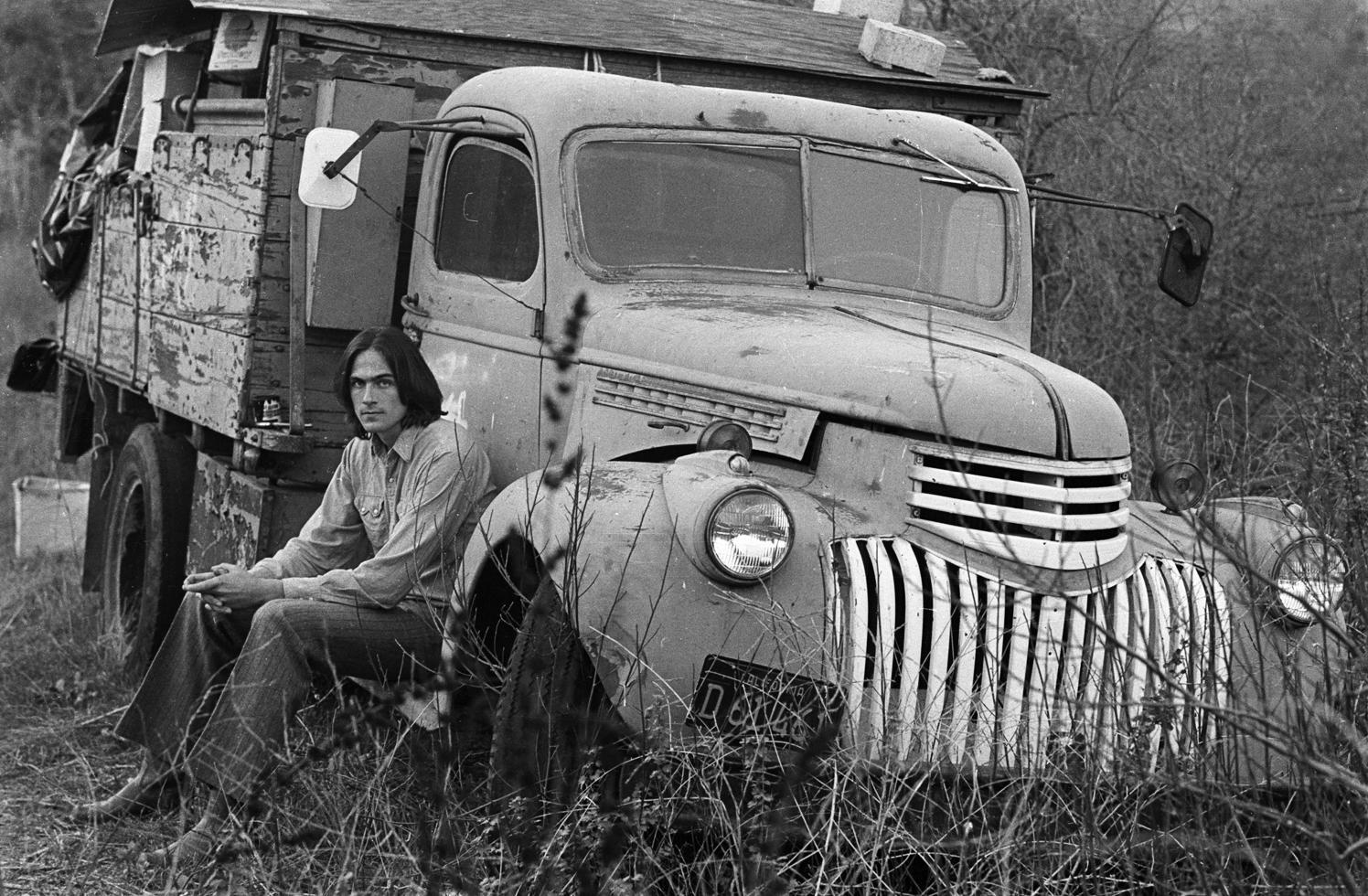 Henry Diltz Black and White Photograph - James Taylor and Old Truck, Lake Hollywood, CA 1969
