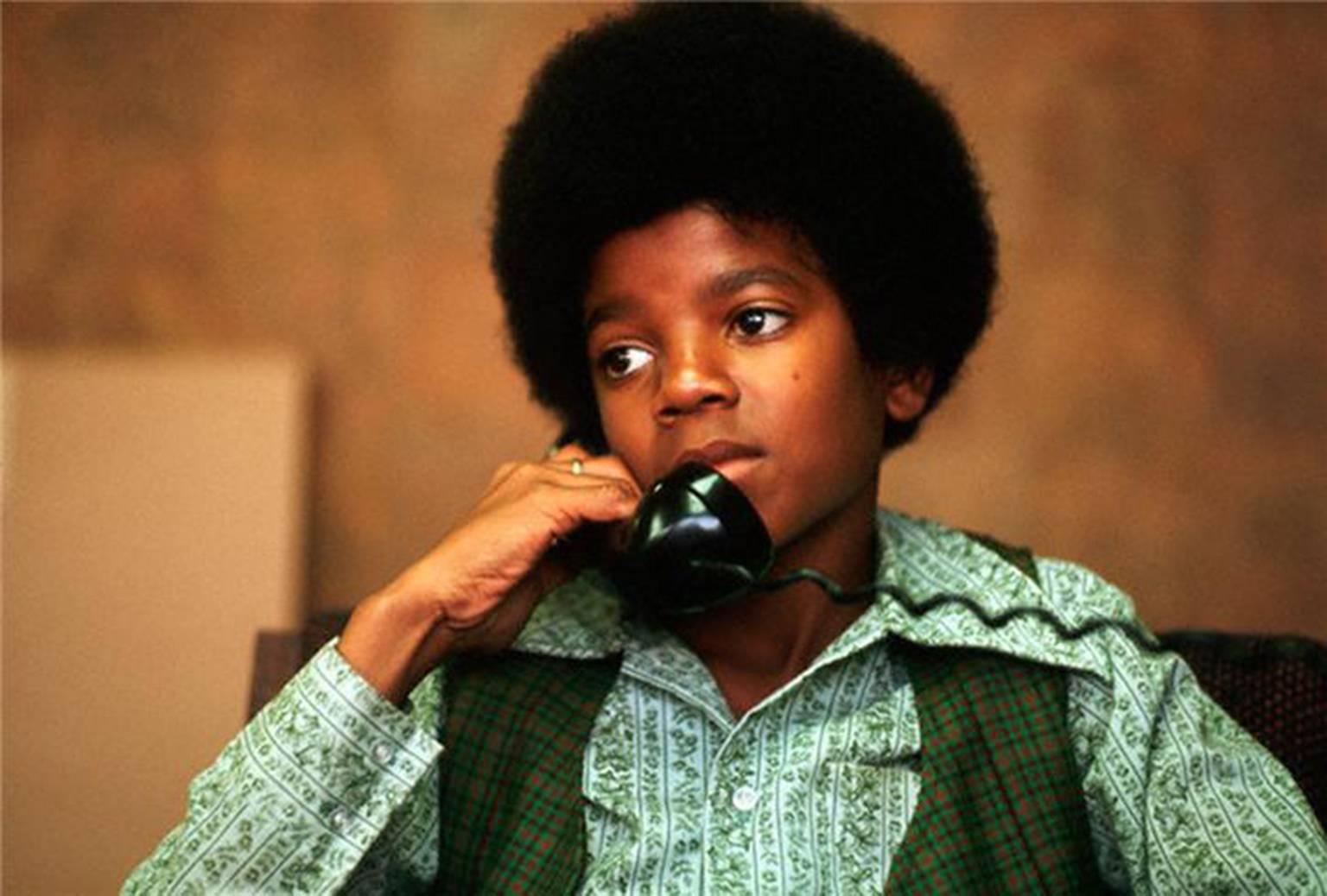 Henry Diltz Portrait Photograph - Michael Jackson on the phone, 1971