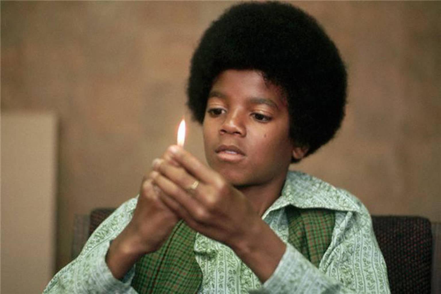Henry Diltz Portrait Photograph - Michael Jackson with Flame, 1971