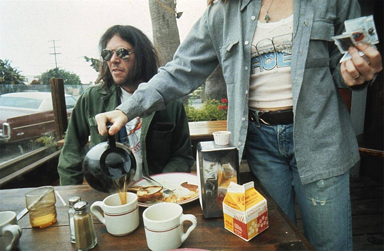 Henry Diltz Portrait Photograph - Neil Young, Breakfast in Malibu, 1975
