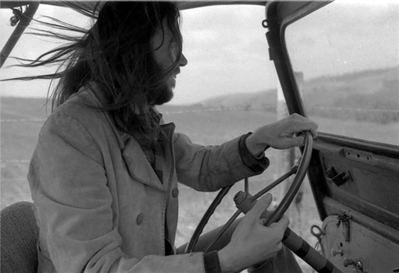 Henry Diltz Black and White Photograph - Neil Young "Jeep, " Malibu, 1975