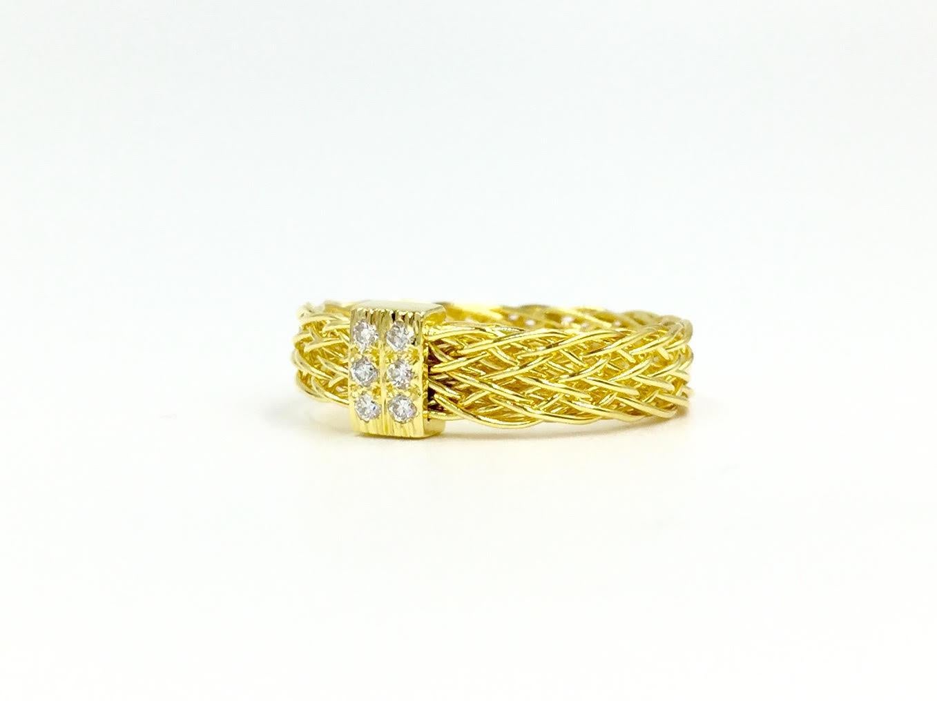 Signed Henry Dunay 18 karat yellow gold woven 4mm band style ring with 6 round diamonds at .10 carats total weight. This stylish ring is wide enough that it can be worn alone or can stack beautifully with other thin rings. 
Finger size 6