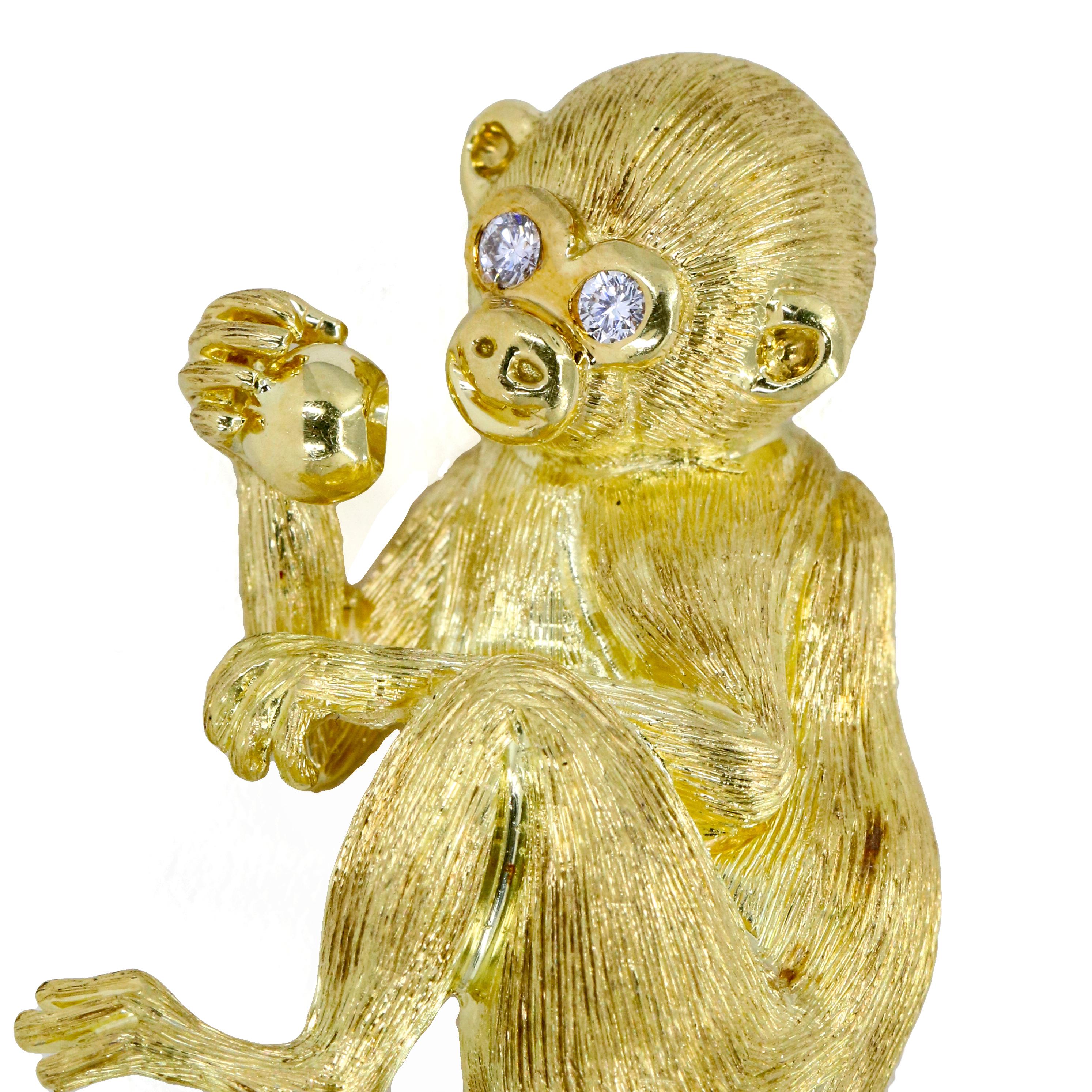 Henry Dunay monkey brooch in 18-karat yellow gold with diamond eyes. 

Length, 52mm
Width, 27mm
Depth, 10mm
Weight, 16.2 grams
Diamond Total Carat Weight, .10 carat 

Previously owned, in excellent condition. Original packaging not included. Cleaned