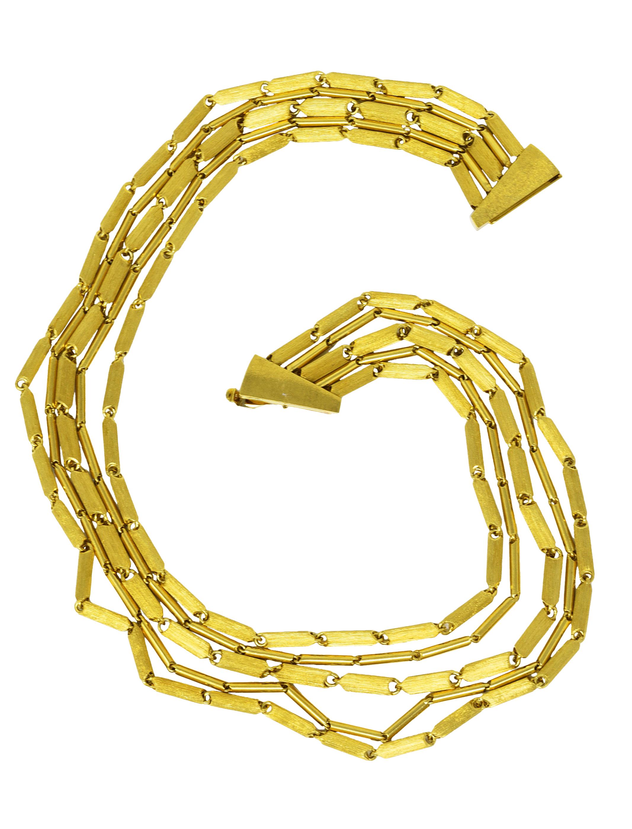 Necklace is designed as five tiered strands of stylized chevron barrel link chains. Strands alternate between wide brushed gold links and thin high polished links. Completed by stylized matte gold slide closure with hinged safety. Stamped 750 and
