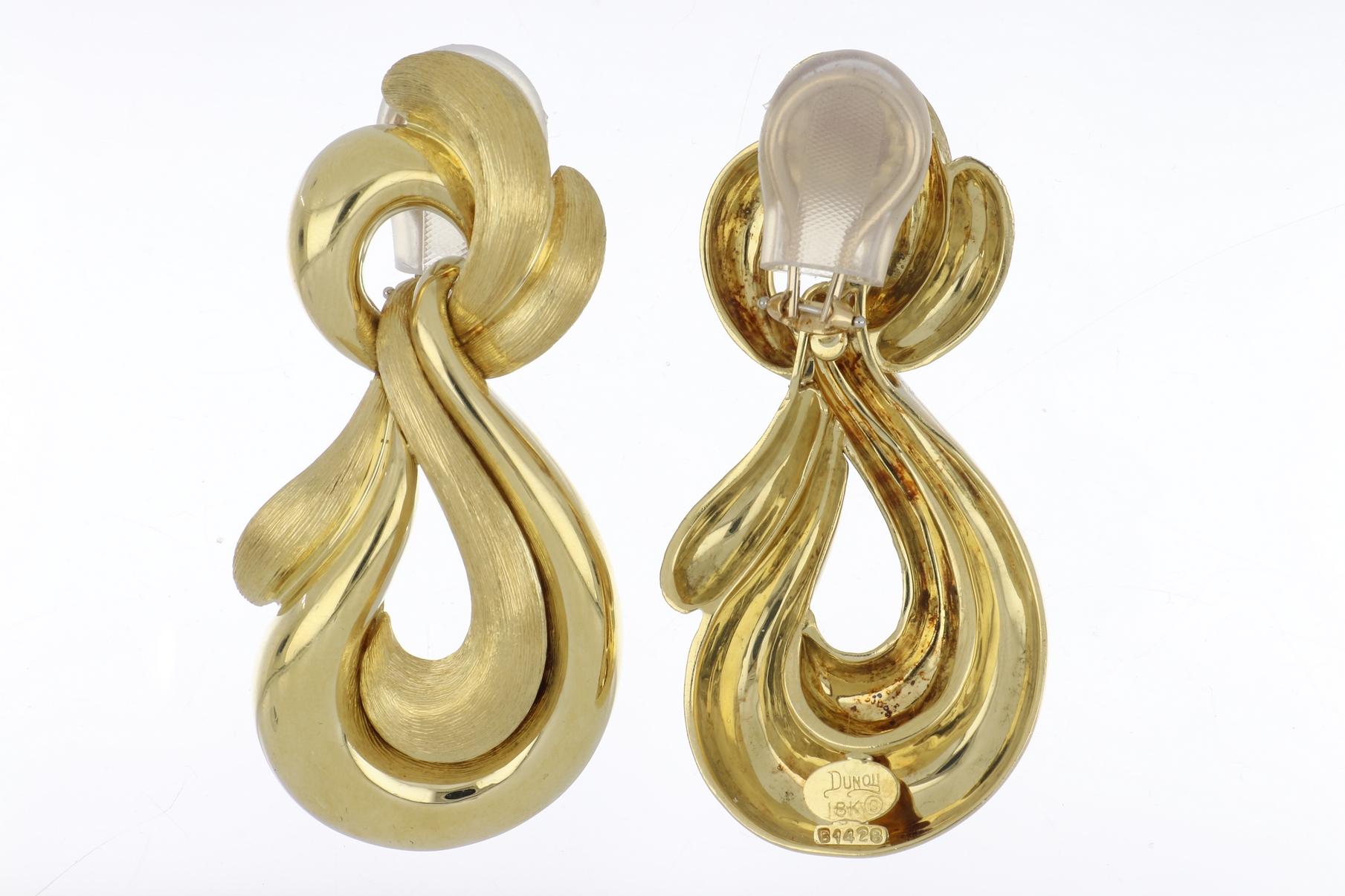 Estate Henry Dunay 18K yellow gold doorknocker earrings in both the Sabi finish and a high polish finish.  A fluid design that measures 2 1/4 inches long and 1 1/4 inches at the widest point.  These earrings have a clip backs and no posts.