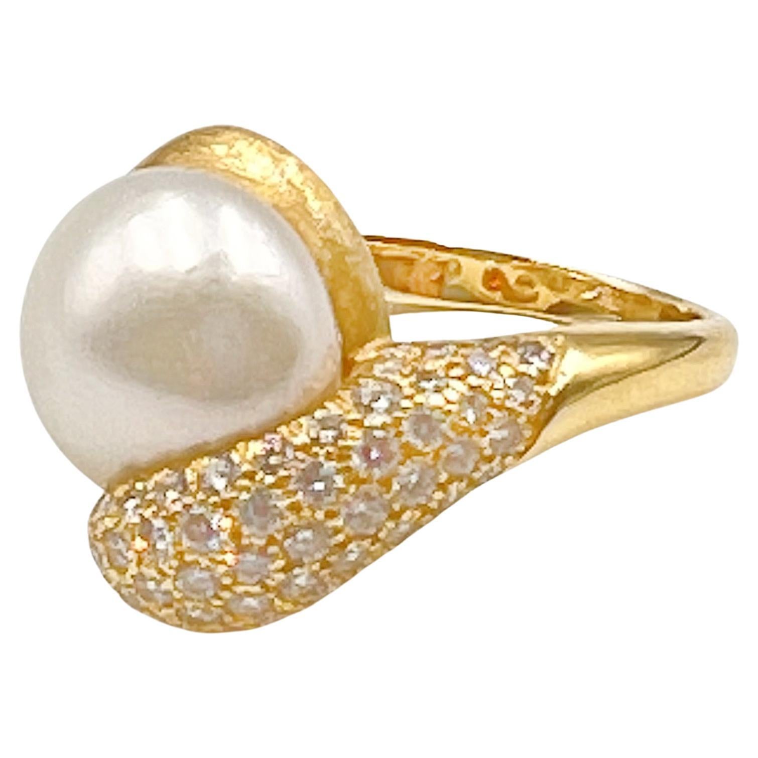 Henry Dunay South Sea pearl and diamond ring with the 'Sabi' finish.  Set with one South Sea cultured pearl measuring 13.25mm.  One side of the mounting is pave-set with 68 round brilliant-cut diamonds weighing approximately 1.70 total carats (F-G
