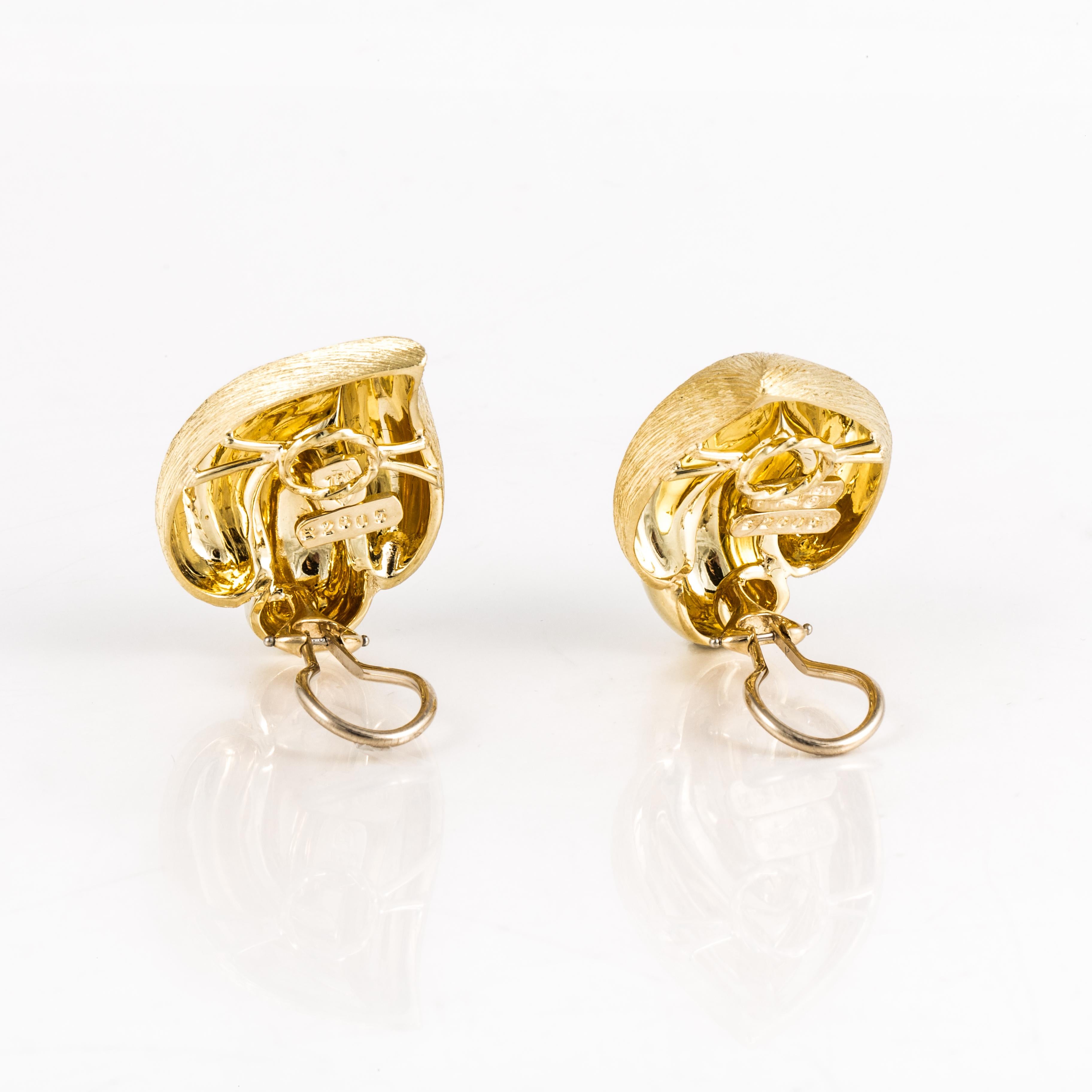 Earrings by Henry Dunay crafted in 18K yellow gold with the Sabi finish combined with a high polish on the front.  Measure 1 3/16 inches long and 7/8 inches wide.