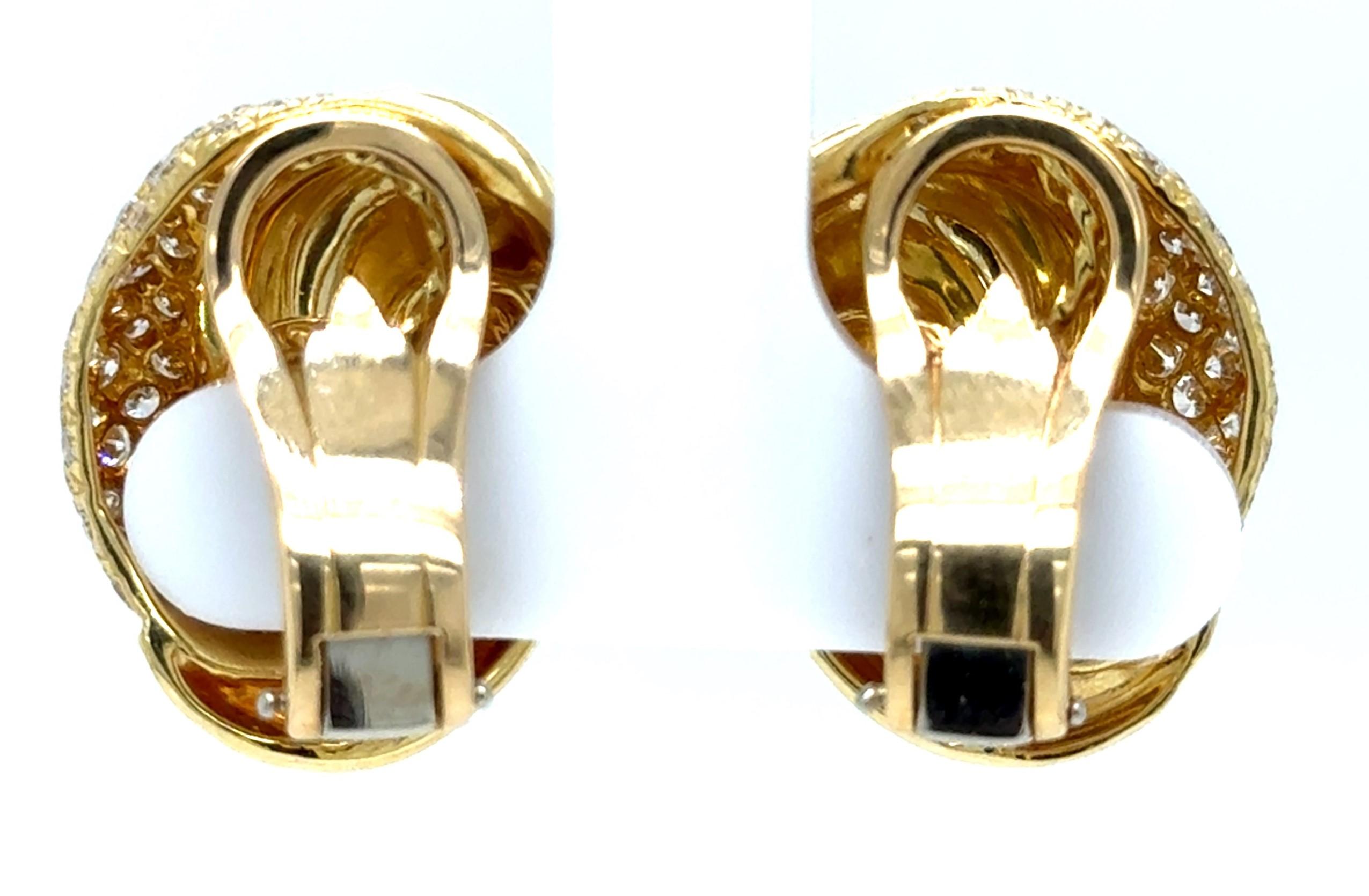 These stunned clip-on earrings have knot-style design of highly polished 18K yellow gold with ninety-two pave set round brilliant-cut natural diamonds (F-G Color, VS Clarity).  They measure approximately 21 x 17mm and weigh 18.4 grams.  Signed