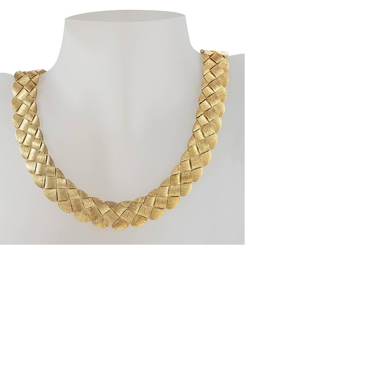 An American Late-20th Century 18 karat gold necklace by Henry Dunay. The highly flexible necklace is composed of a basketweave link pattern with Henry Dunay’s distinctive surface texturing and unique gold color. Unique Dunay slide clasp. Circa