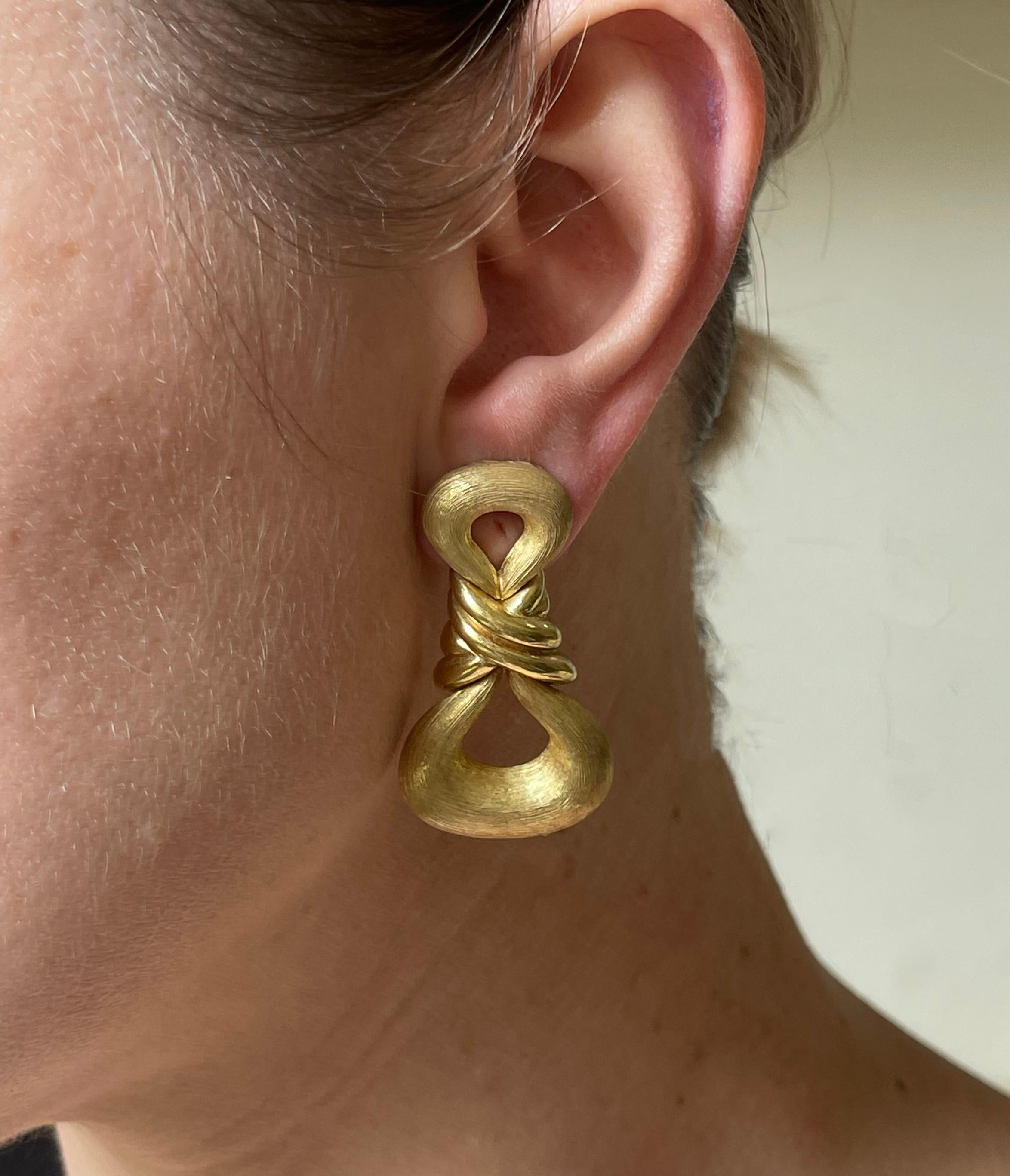 Pair of 18k gold earrings by Henry Dunay, with signature recognizable brushed finish, alternating with high polish. The earrings measure 1.75