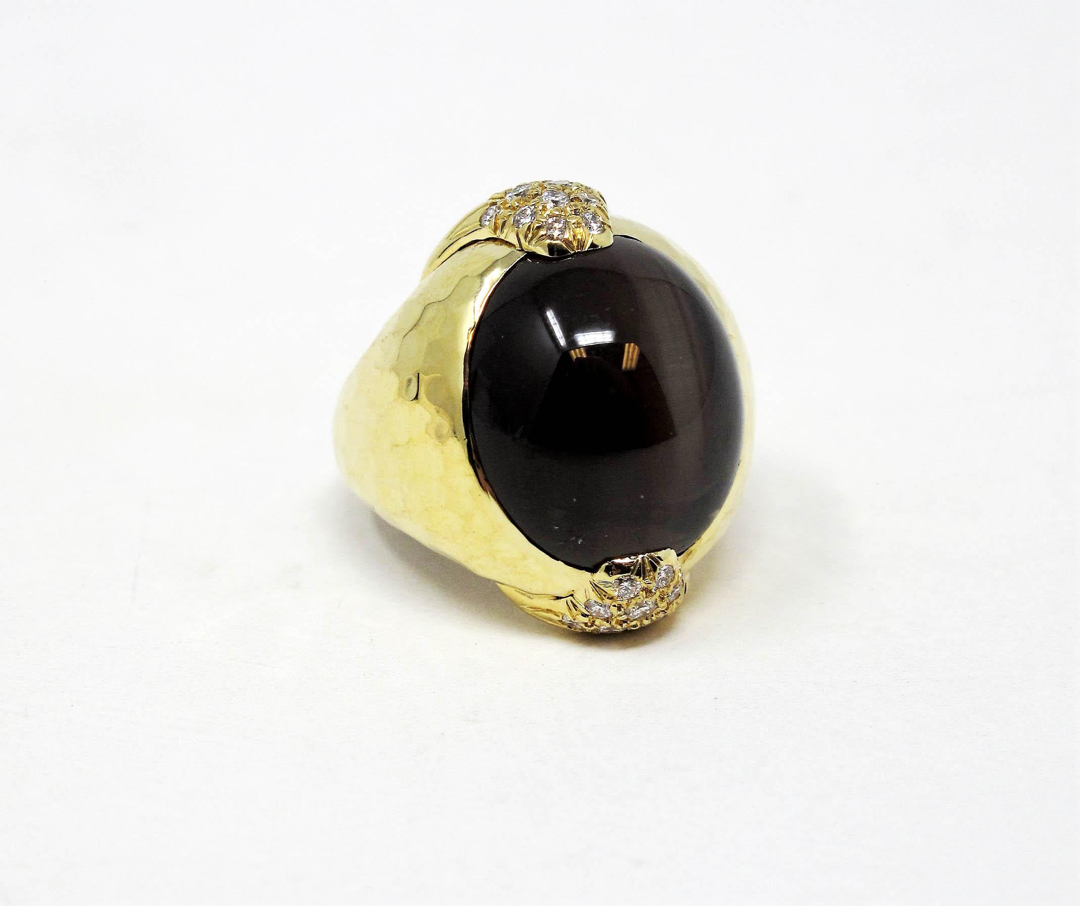 This absolutely gorgeous contemporary cat's eye sillimanite and diamond dome ring made by Henry Dunay will be you new signature piece. Adorn your finger with this stunning cabochon cut medium brown stone with unique cat's eye characteristics that