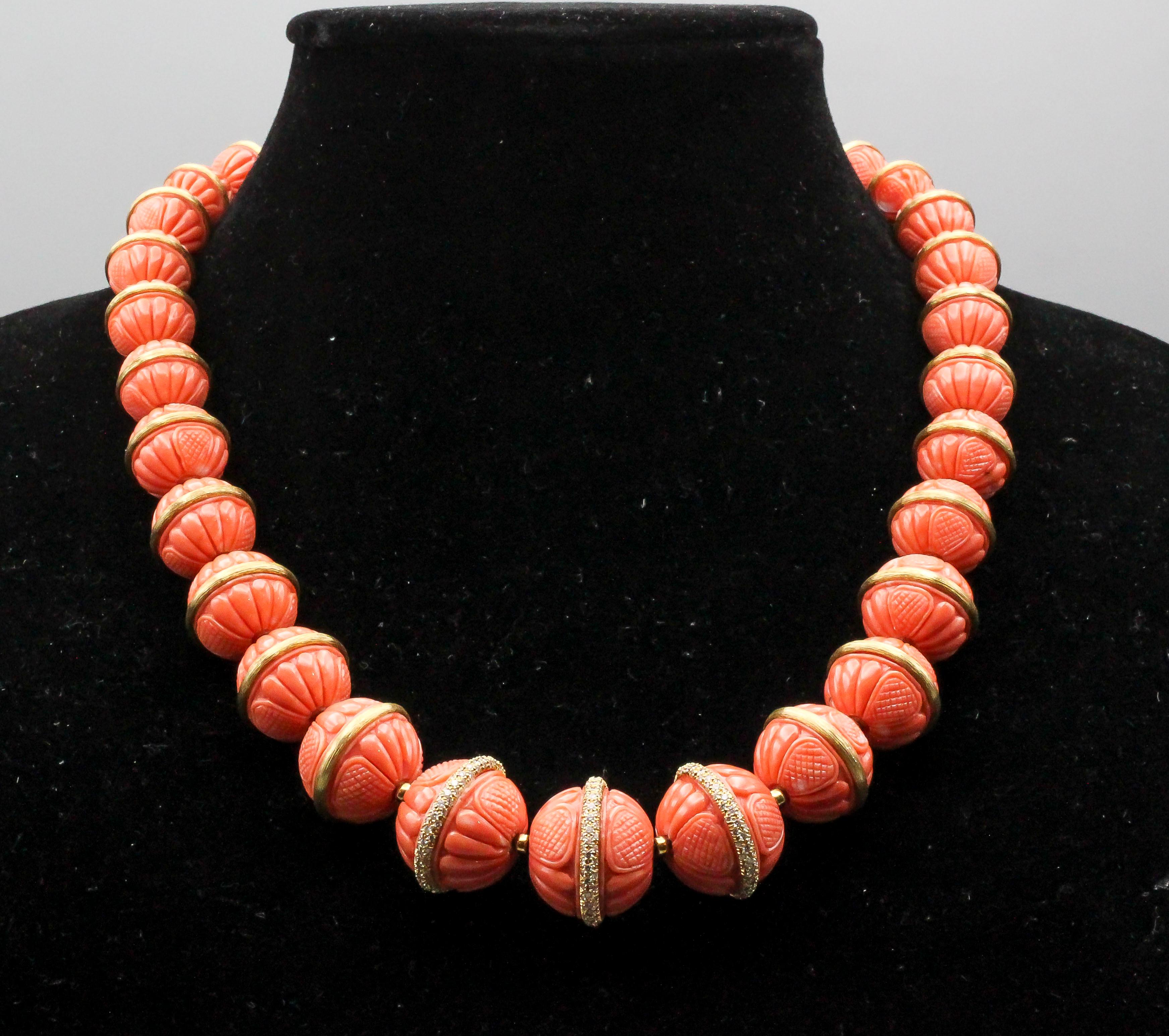 Impressive coral, diamond and 18K yellow gold necklace and bracelet suite by Henry Dunay. The coral beads on necklace range in size from 11mm to 20mm in diameter; the bracelet corals measure 9mm to 11mm in diameter. The corals are a rich salmon