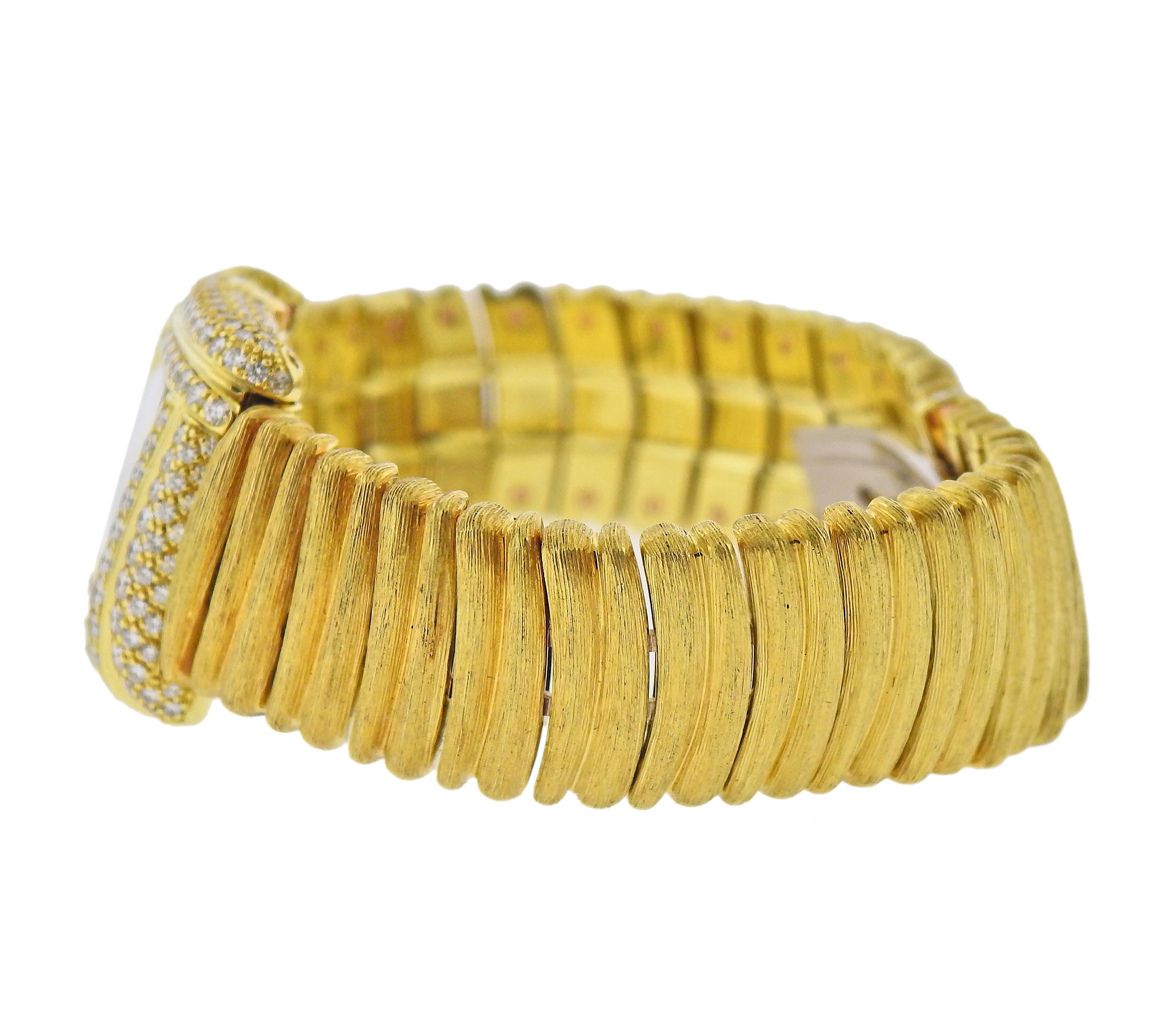 18k yellow gold brushed finish watch bracelet by Henry Dunay, case and dial adorned with approx. 2.40ctw in diamonds. Case measures 23mm x 28mm. Bracelet will fit approx. 6.75