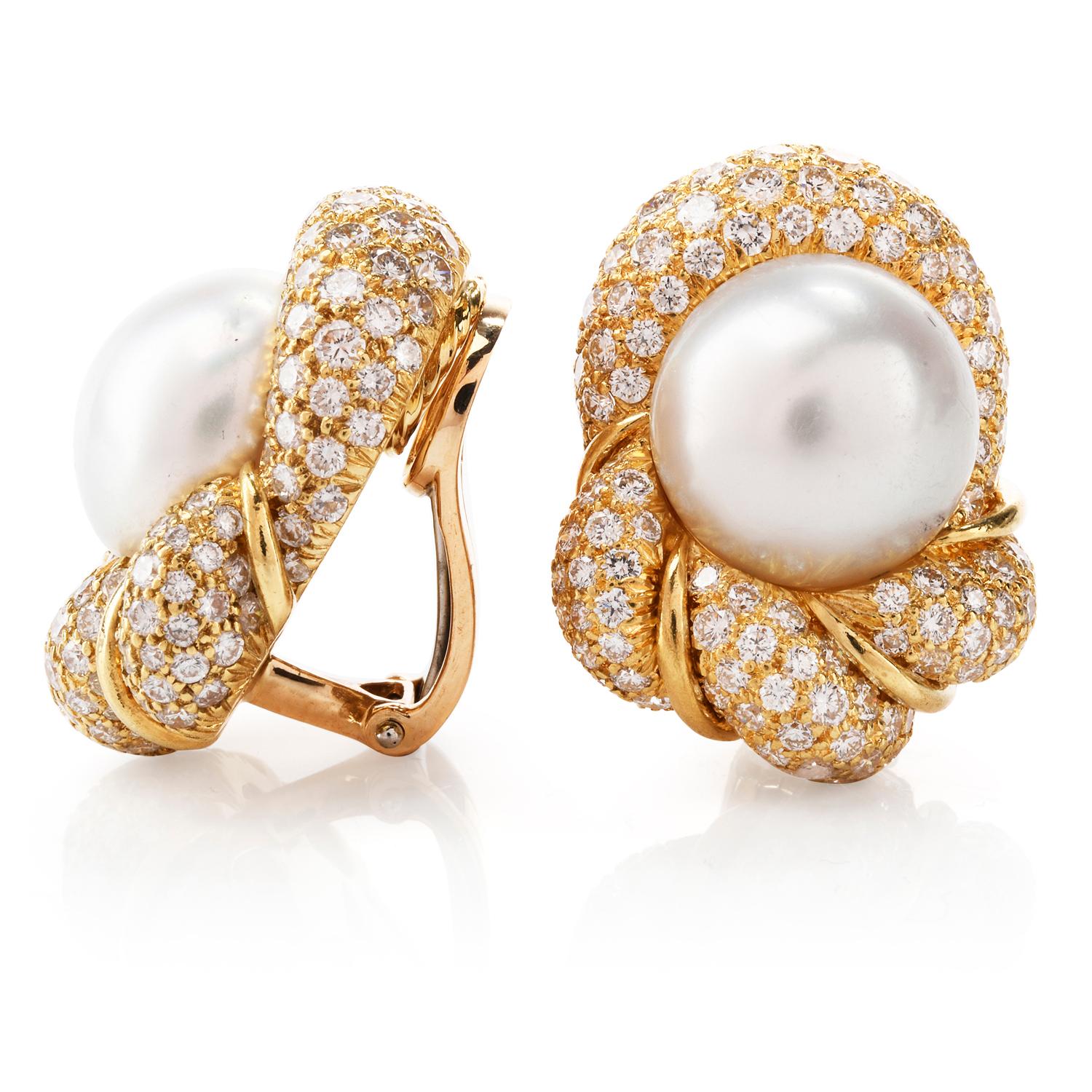 These Henry Dunay designed earring were created to encompass these 2 beautiful South Sea Pearls appx. 13mm in diameter.

Crafted in 18K yellow gold, each earring has been filled with pave set round diamonds cumulatively weighing approx. 7.63 carats