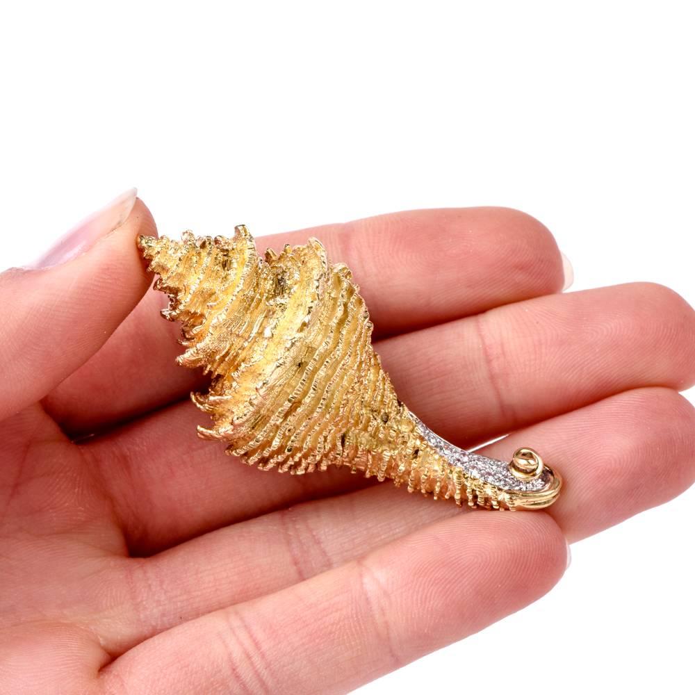 This artfully designed estate Henry Dunay pin brooch simulates an accurately sculptured image of a conch shell, with its multiple layers and shape resembling a cornucopia displayed accurately by means of immaculate texturing of yellow gold. The