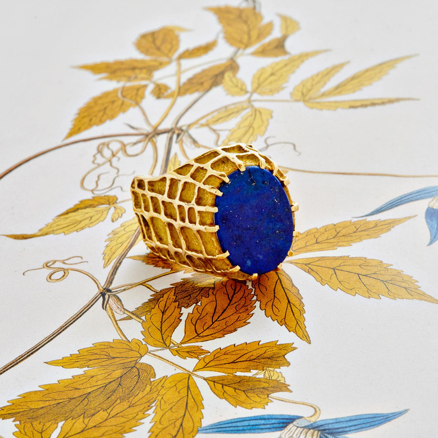 Master jeweler Henry Dunay is known for his intricately worked gold surfaces. This modern take on a cocktail ring features vibrant lapis lazuli set in a textured gold honeycomb design mount.

.84