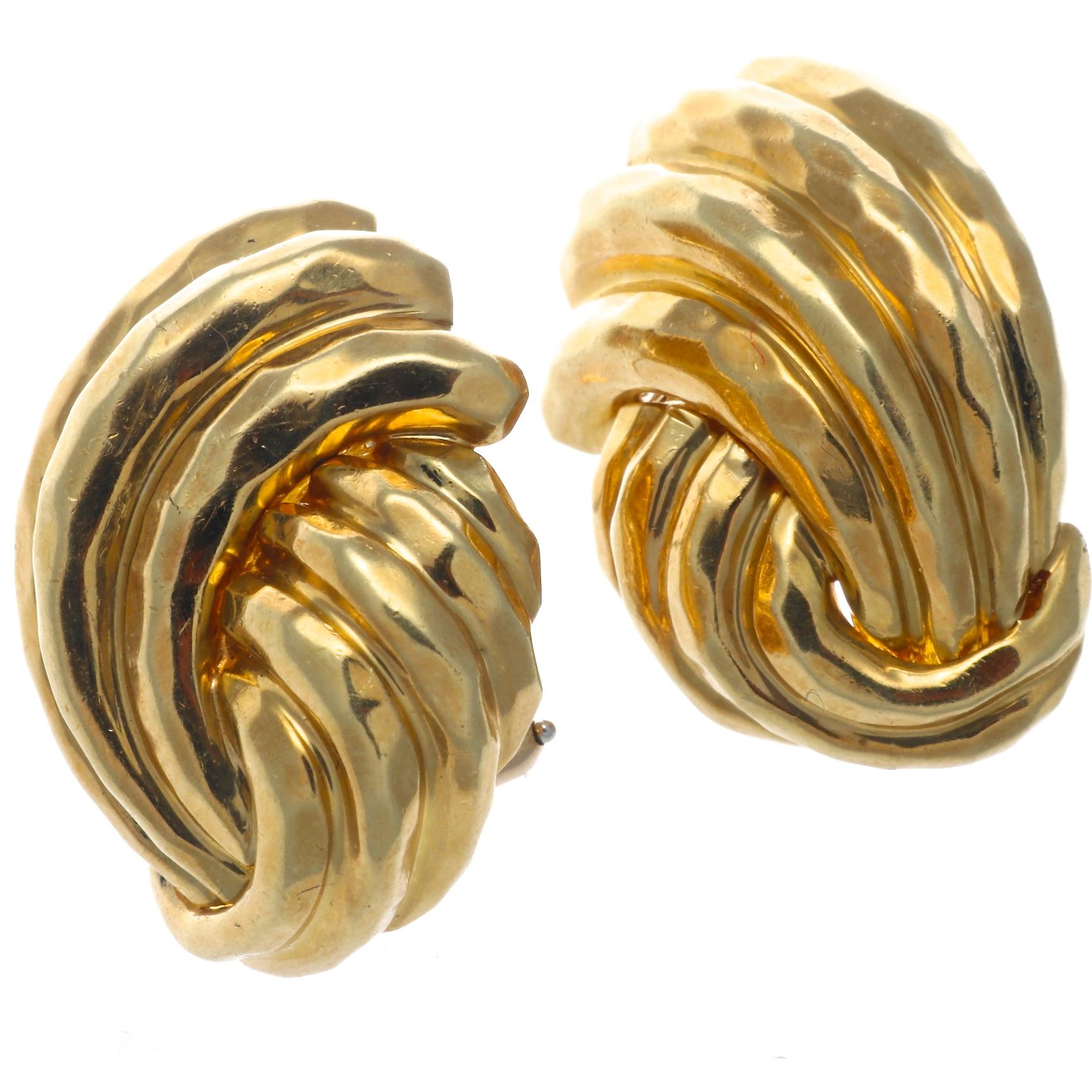 The texture on these circa 1980's Henry Dunay 18k gold hammered earrings gives them a richness and depth that make them irresistible. Total weight is 26.1 grams. Measurements are 1 inch x 3/4 inch
Signed Dunay and stamped 18k. 