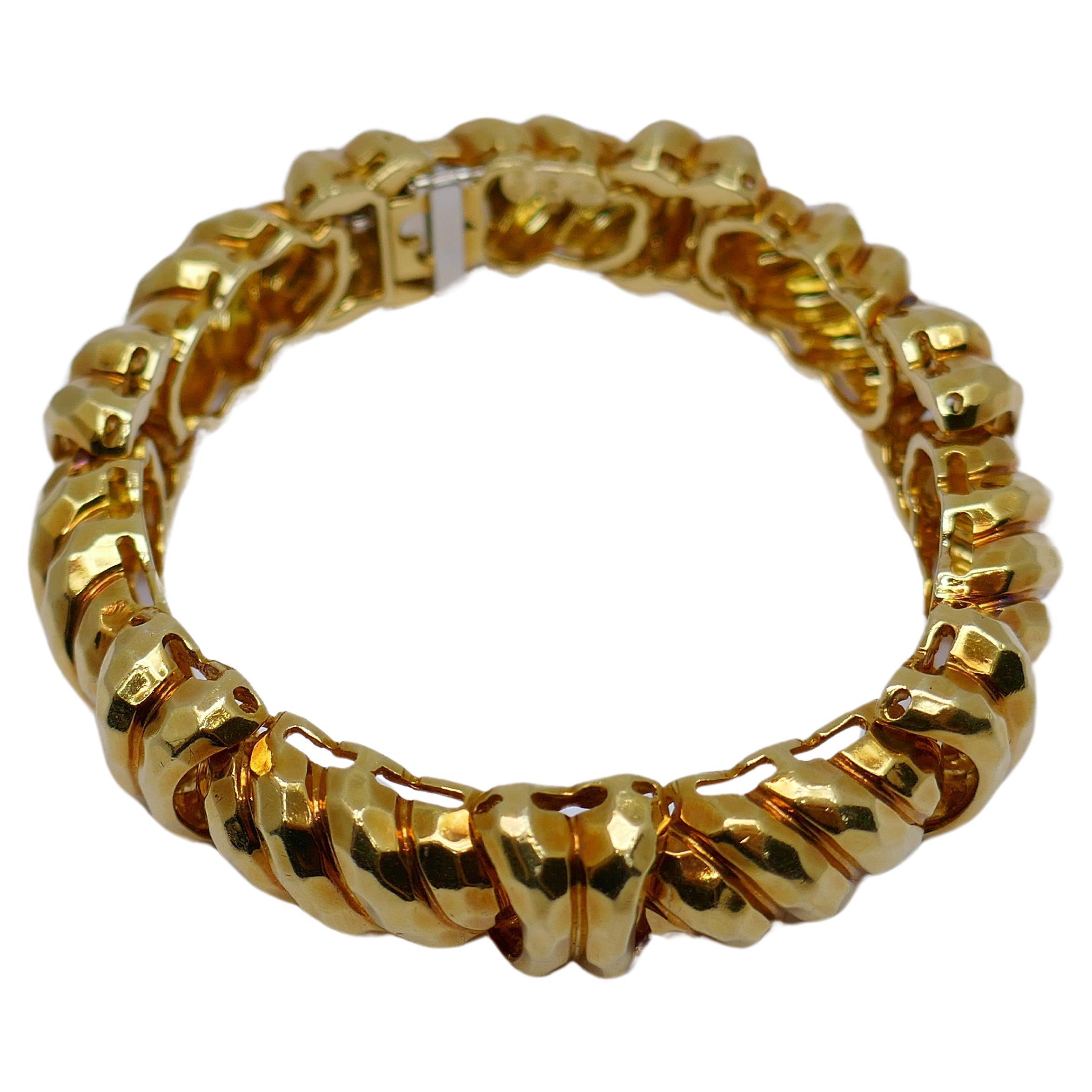 A gorgeous 18k gold bracelet by Henry Dunay. Made of the sparkly hammered gold, Dunay's signature style. The faceted surface  beautifully reflects the light. Due to this technique, Dunay's pieces are not only unique looking but also extremely