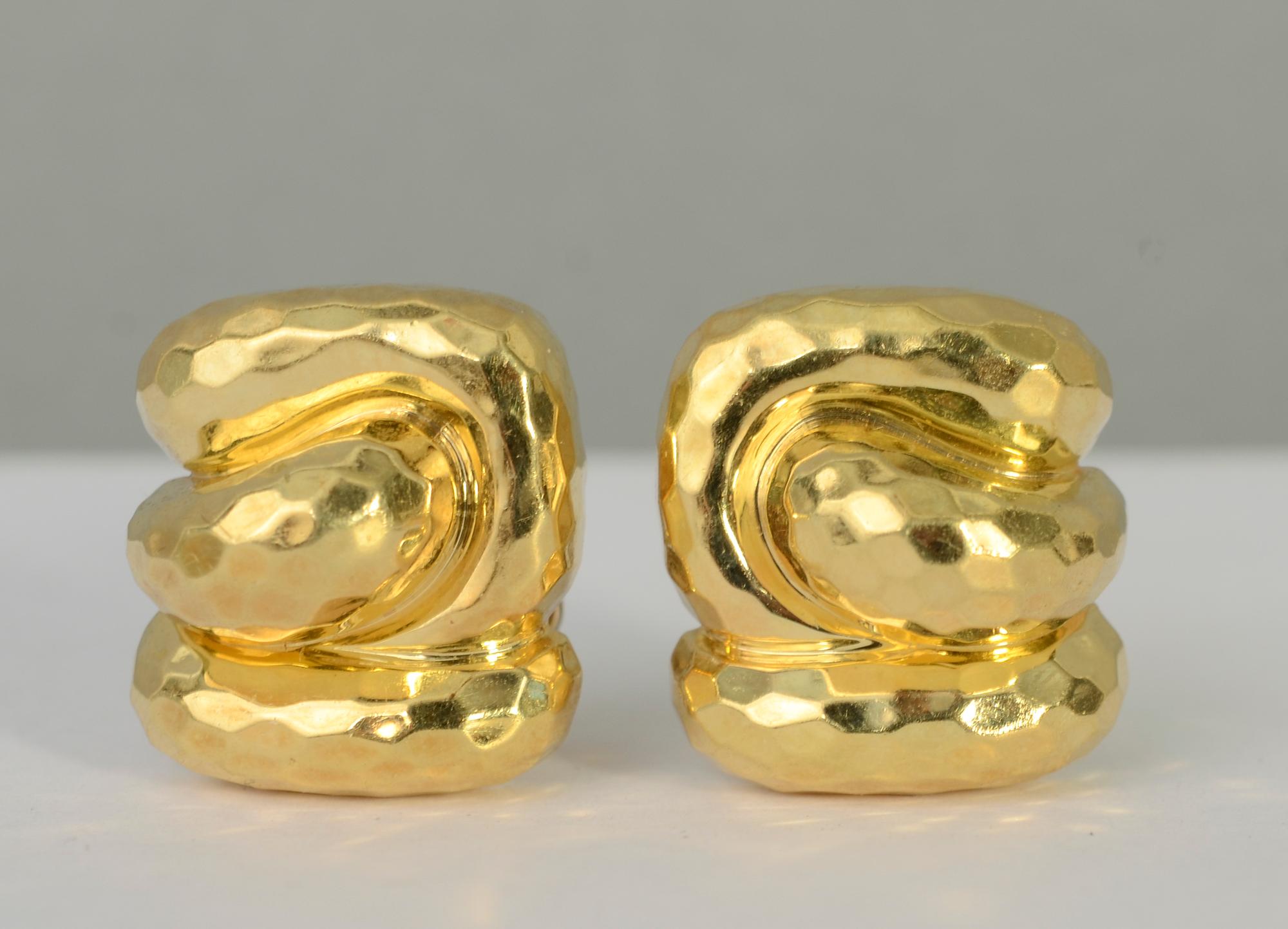 Tailored and chic gold earrings by Henry Dunay. They are made with the hammered gold finish for which he is well known. The earrings have a terrific abstract sculptural design. Backs are clips and posts.
