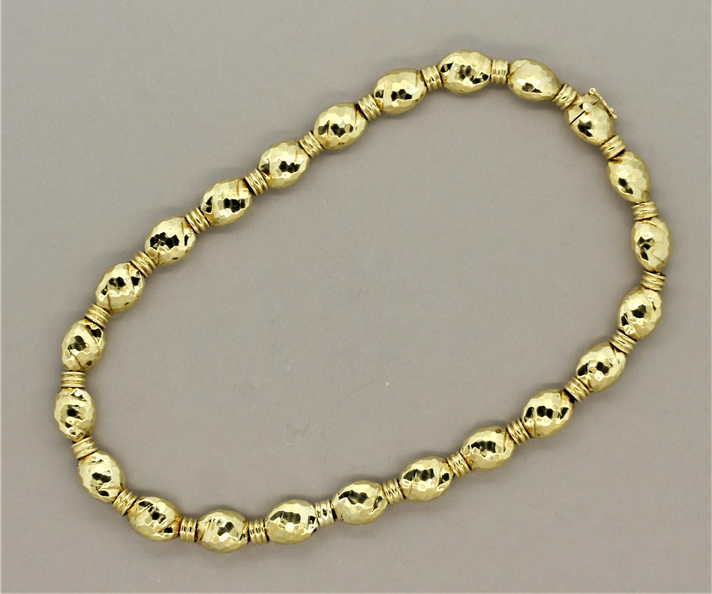 A classic piece by designer Henry Dunay featuring their renowned gold-work. This 18k yellow gold necklace way hand worked to form faceted gold beads with a high polish. Signed with the original makers-mark “Dunay” and “18k.”

Length: 16 inches