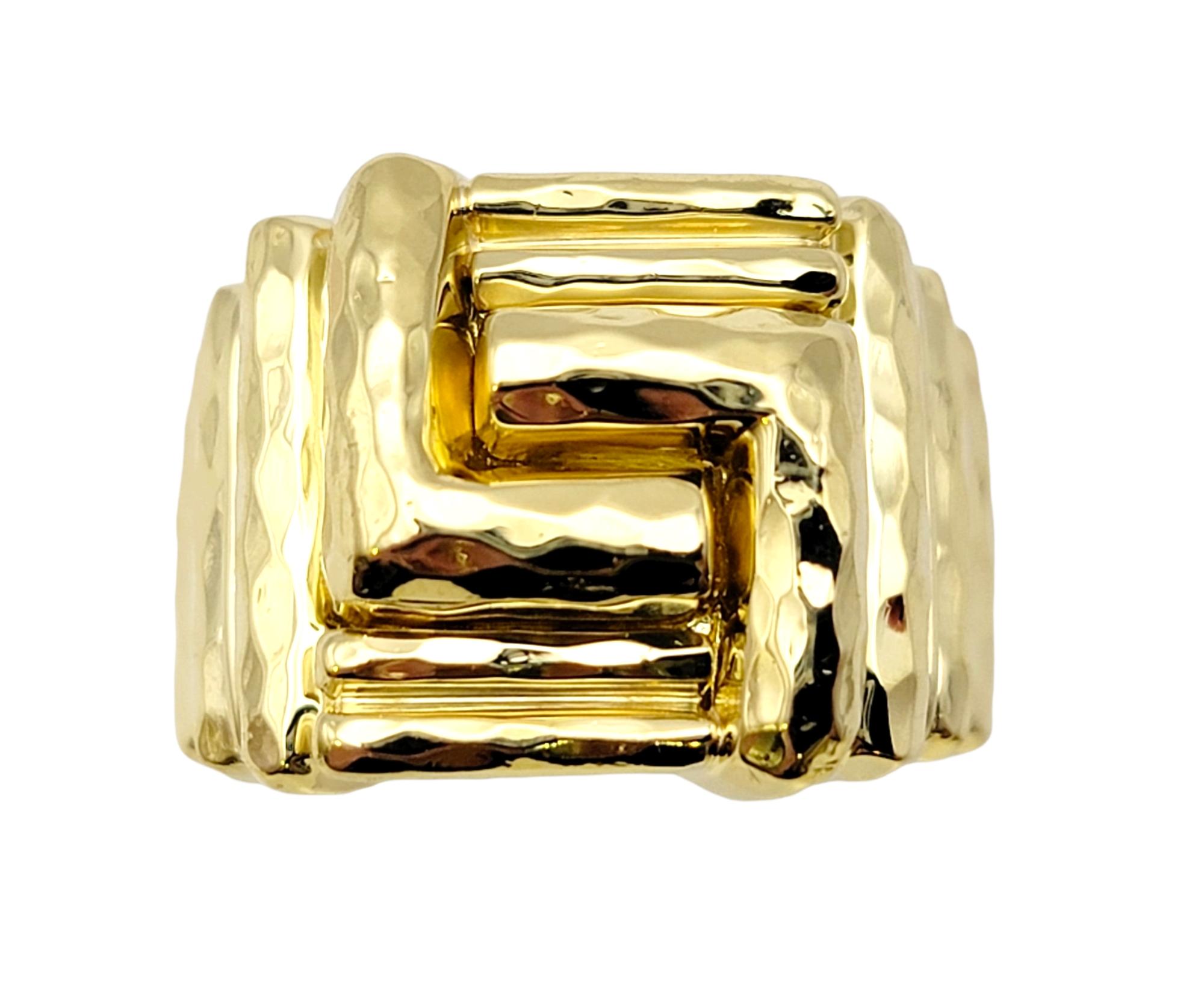 Ring size: 7.25

Uniquely textured hammered 18 karat yellow gold band ring by American jewelry designer, Henry Dunay. The contemporary geometric design offers understated sophistication, while the luxurious gold setting offers a sleek, polished