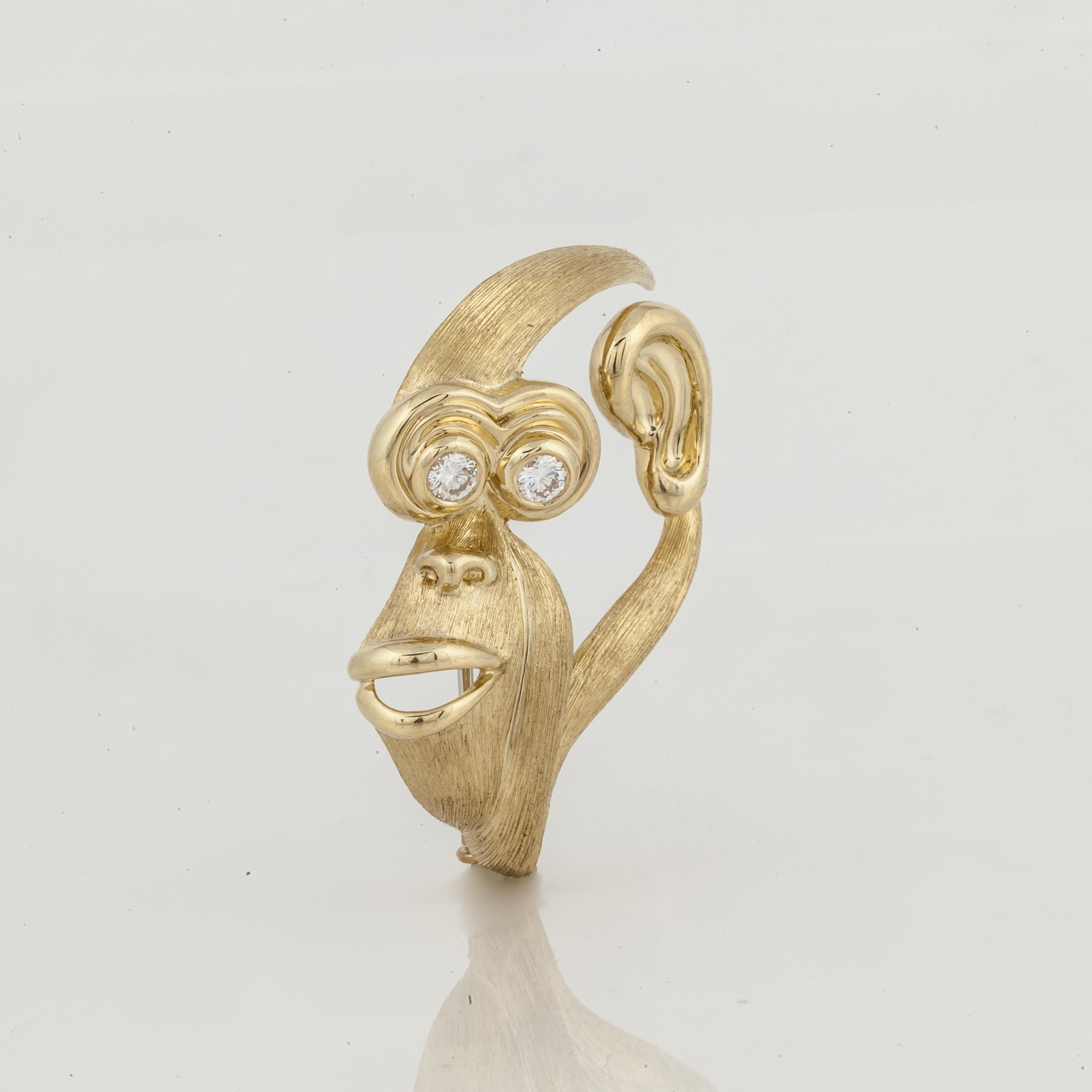 This Henry Dunay brooch depicts the profile of a monkey's face in 18K yellow gold with both a high polish and Sabi finish.  It is marked 