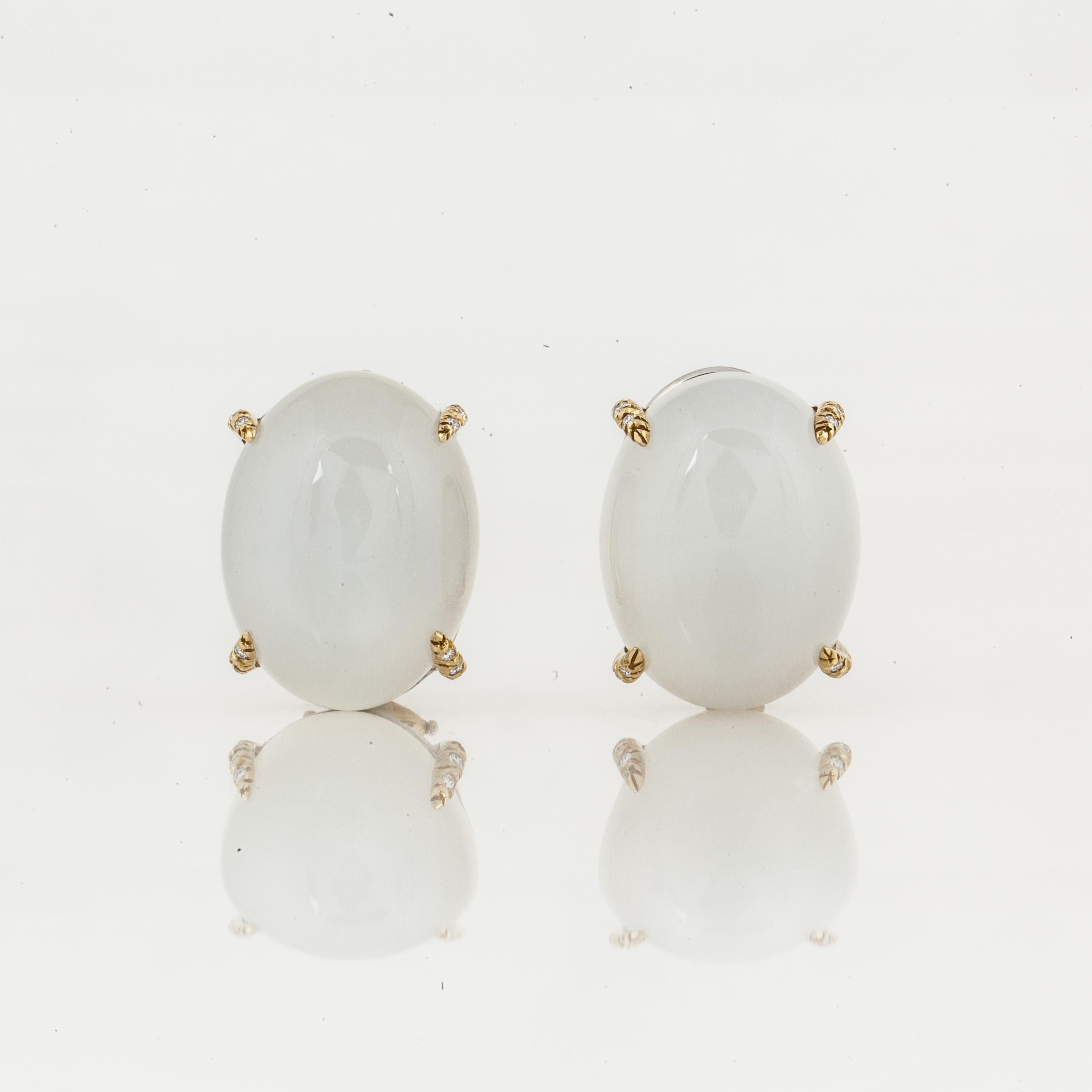 Henry Dunay earrings composed of 18K yellow gold and platinum with moonstones and diamond accents.  They are marked 