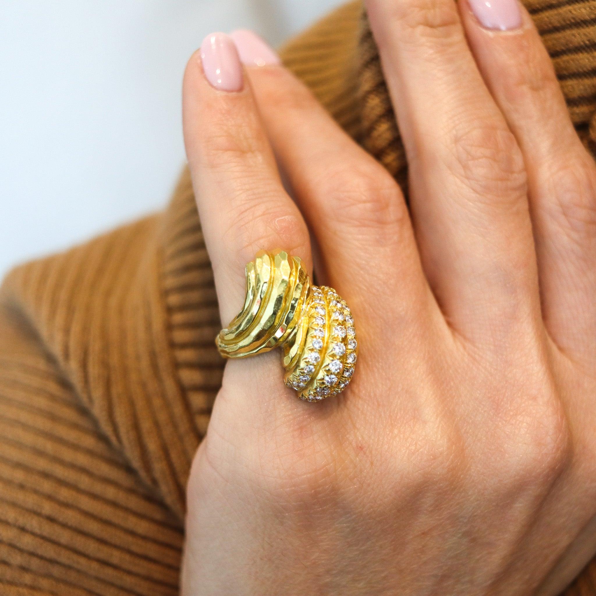 A cocktail ring designed by Henry Dunay.

This is a beautiful cocktail ring, created in New York City at the jewelry atelier of Henry Dunay, back in the 1990. The ring has been crafted in the shape of a bypass or toi et moi in solid yellow gold of