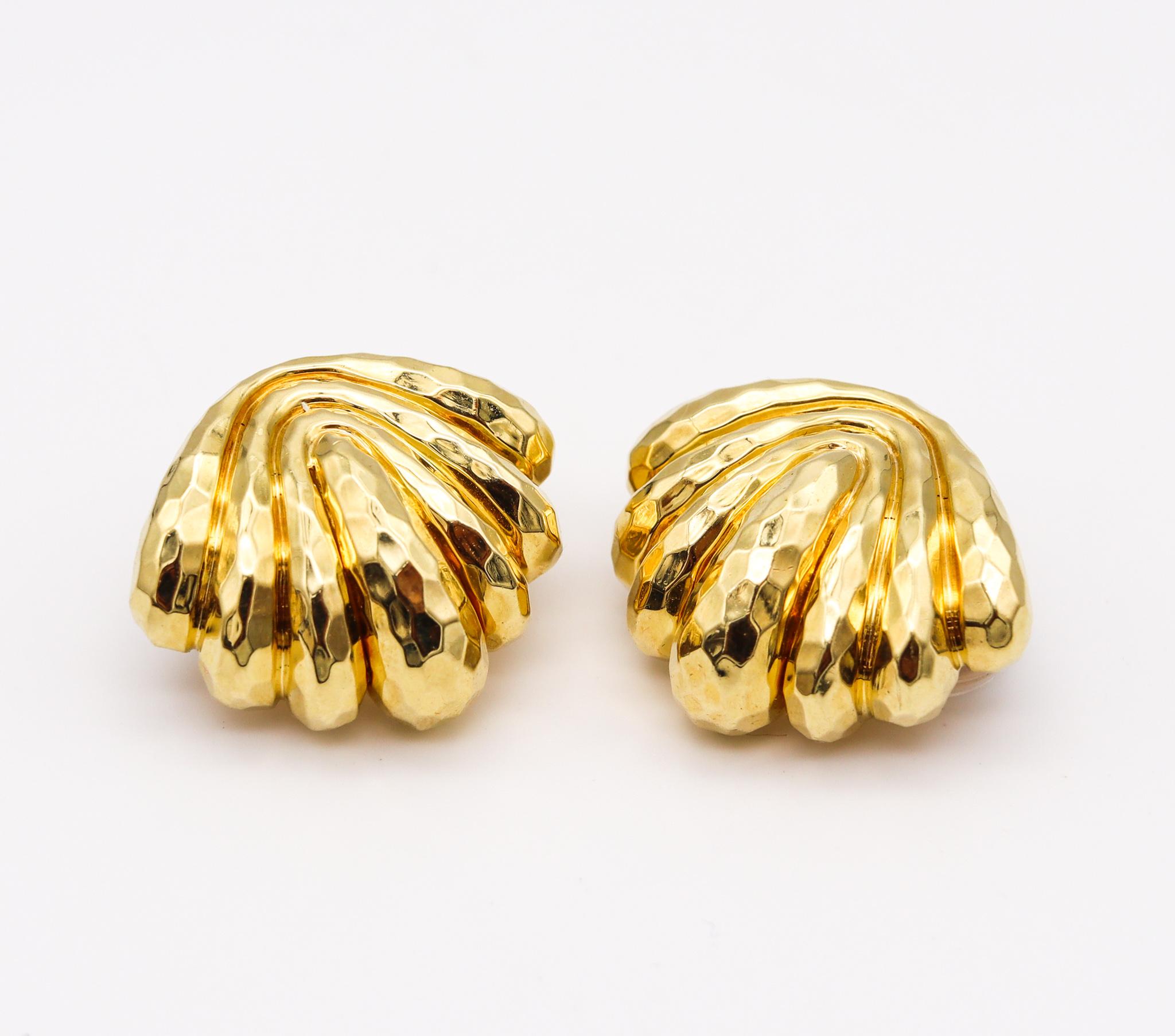A pair of clips earrings designed by Henry Dunay.

Great hammered and Faceted ear-clips, created at the Henry Dunay atelier in New York city, back in the 1990's. They were carefully crafted in solid yellow gold of 18 karats with the surfaces