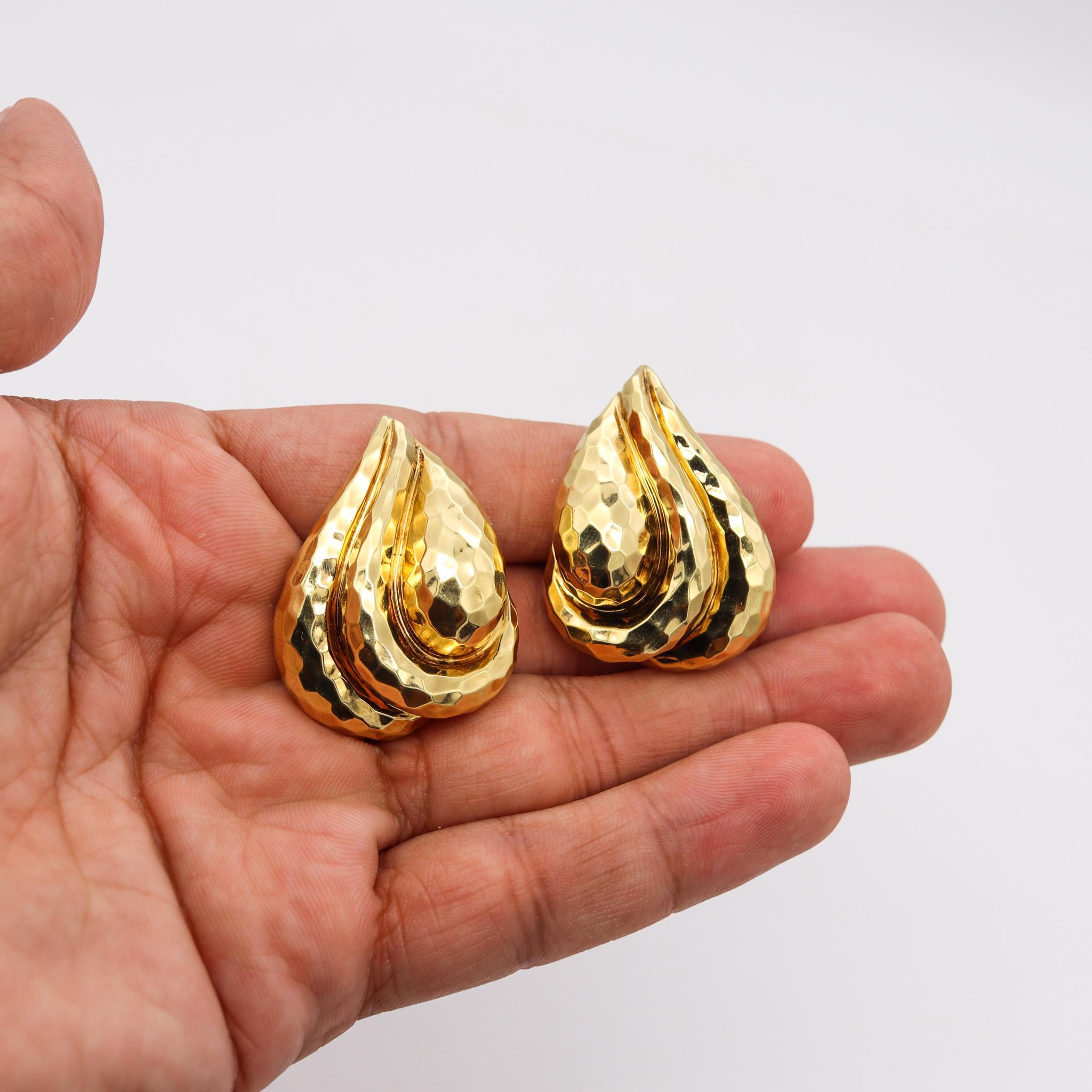 Pair of earrings designed by Henry Dunay.

Large pair of clip-on earrings, created in New York city at the jewelry atelier of Henry Dunay, back in the 1990's. They are totally crafted in solid rich yellow gold of 18 karats and the surfaces are