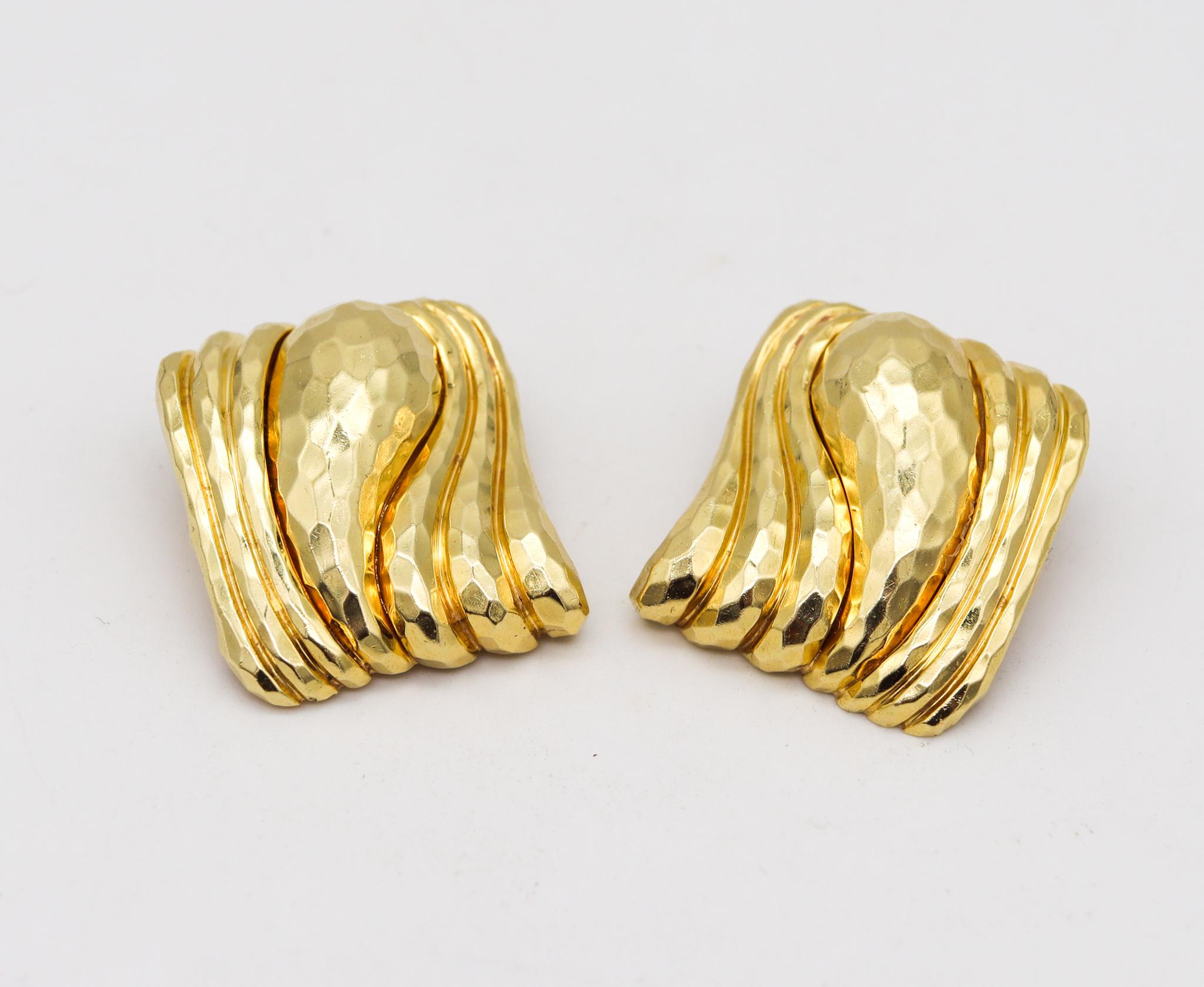 A pair of earrings designed by Henry Dunay.

Great hammered (Faceted) ear-clips, created at the Henry Dunay atelier in New York city around the 1990. They are crafted in solid yellow gold of 18 karats with the entire surface finished with the iconic