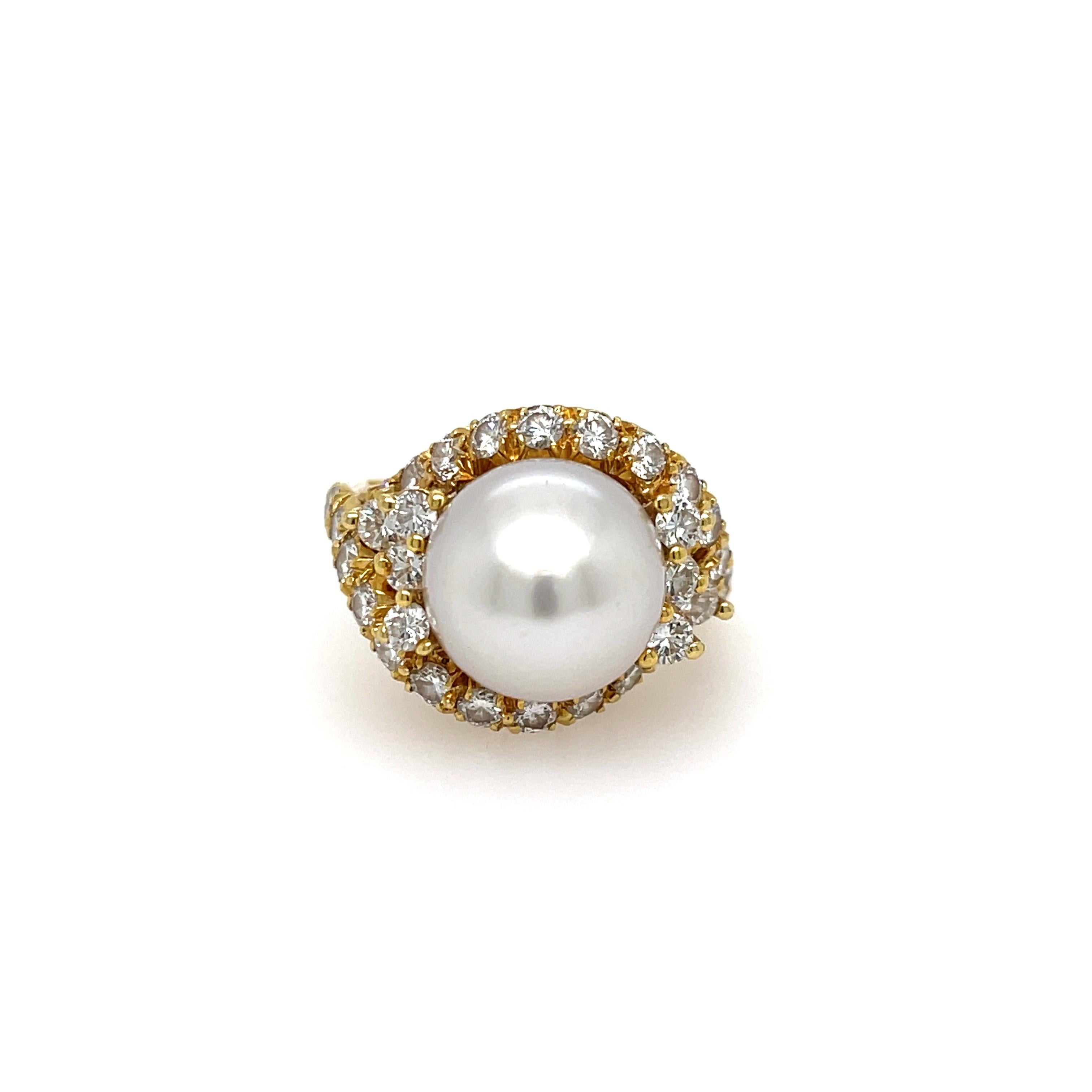 Estate Henry Dunay Pearl and Diamond Ring in 18K Yellow Gold. The ring features a 11.8mm cultured pearl and 32 brilliant cut diamonds. Ring size 8.
11.95 Grams