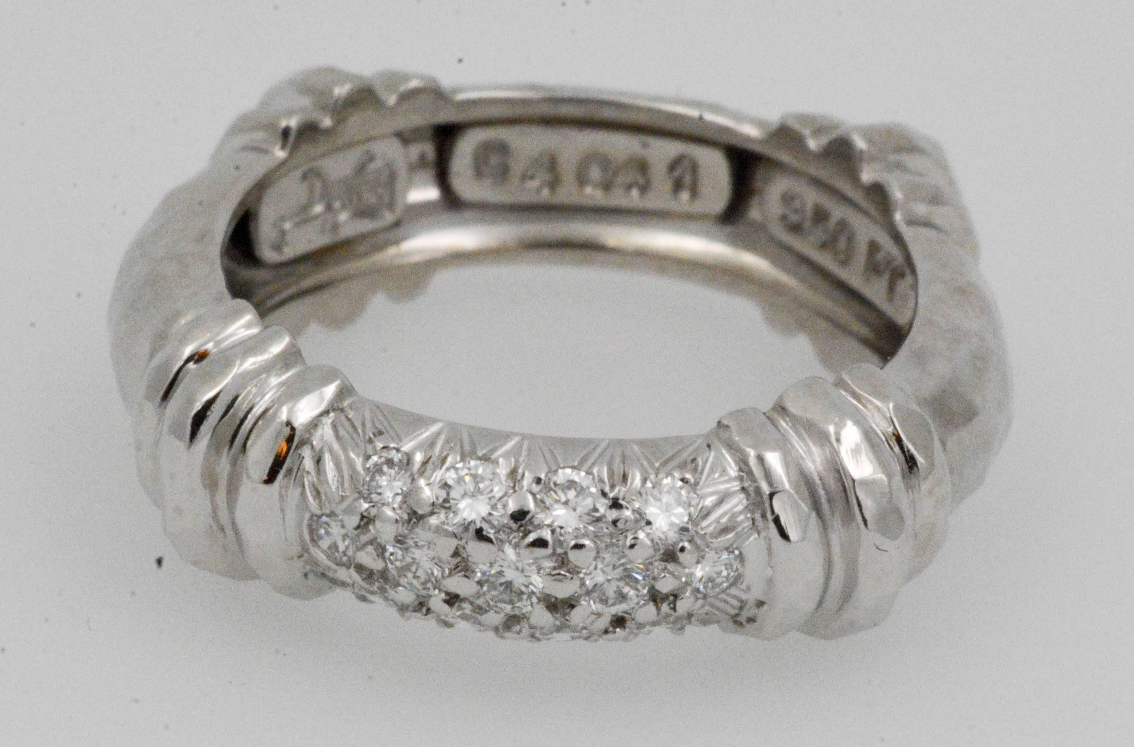 Captivating, exquisite and not your ordinary platinum band with pave set diamonds created by Henry Dunay. This 1980's platinum ring is a fabulous creation with finely hand-etched faceted finishes. 13 round brilliant cut diamonds are pave set (.30