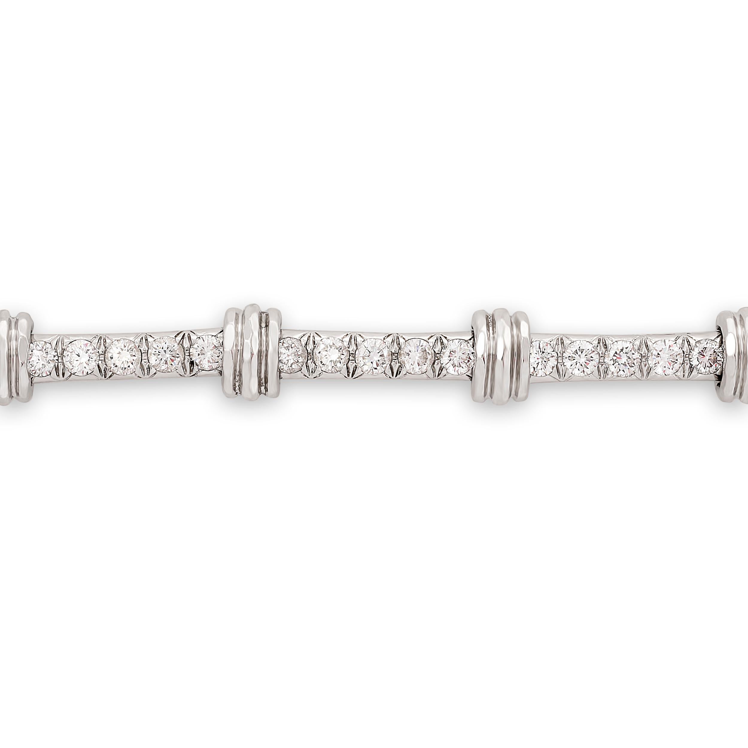 A Henry Dunay diamond bracelet boasts a unique hammered texture. This listing is for the bracelet only; the matching necklace is a separate listing.

The bracelet, made in platinum, has 15 round brilliant diamonds that weigh approximately 1.80 total