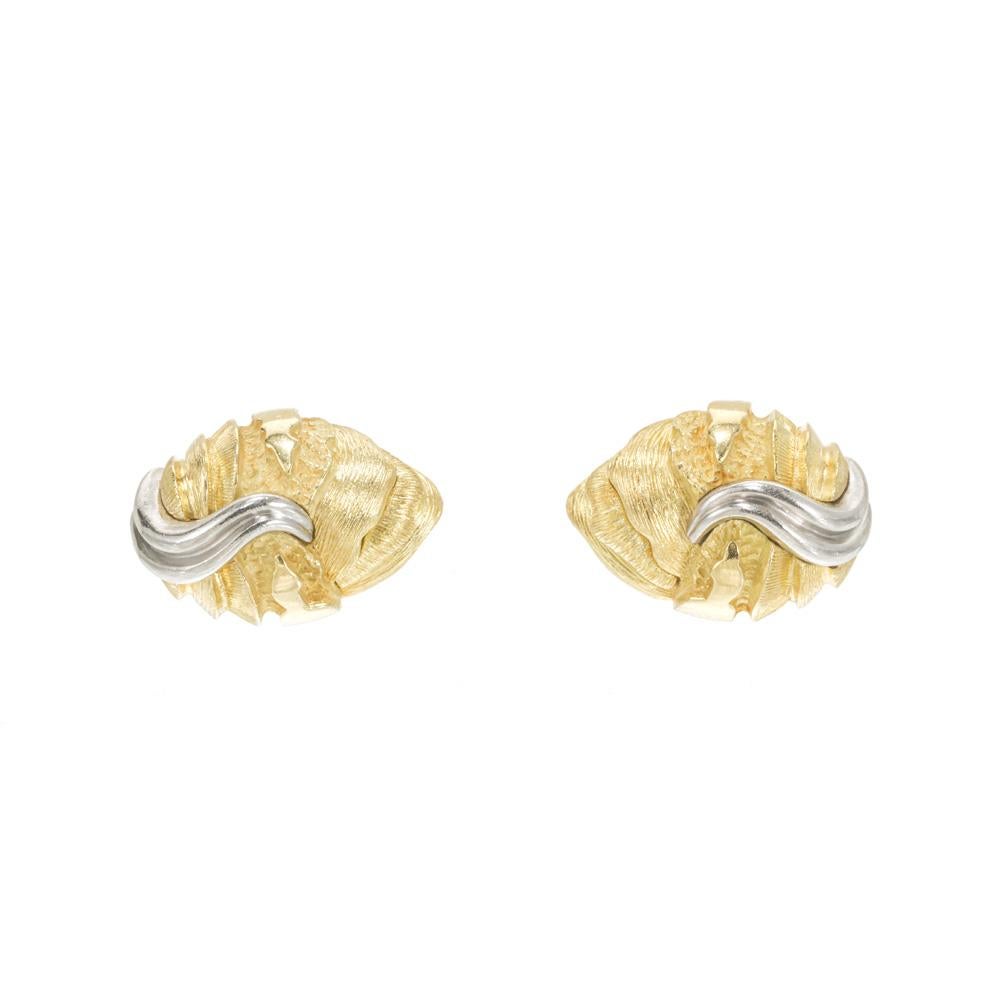 Henry Dunay platinum and 18k gold clip post earrings. Textured yellow gold oval earrings each with a platinum swirl.  circa 1990

18k yellow gold 
Stamped: 18k
Tested: Platinum
Hallmark: Dunay
16.6 grams
Top to bottom: 19.6mm or .77 Inches
Width: