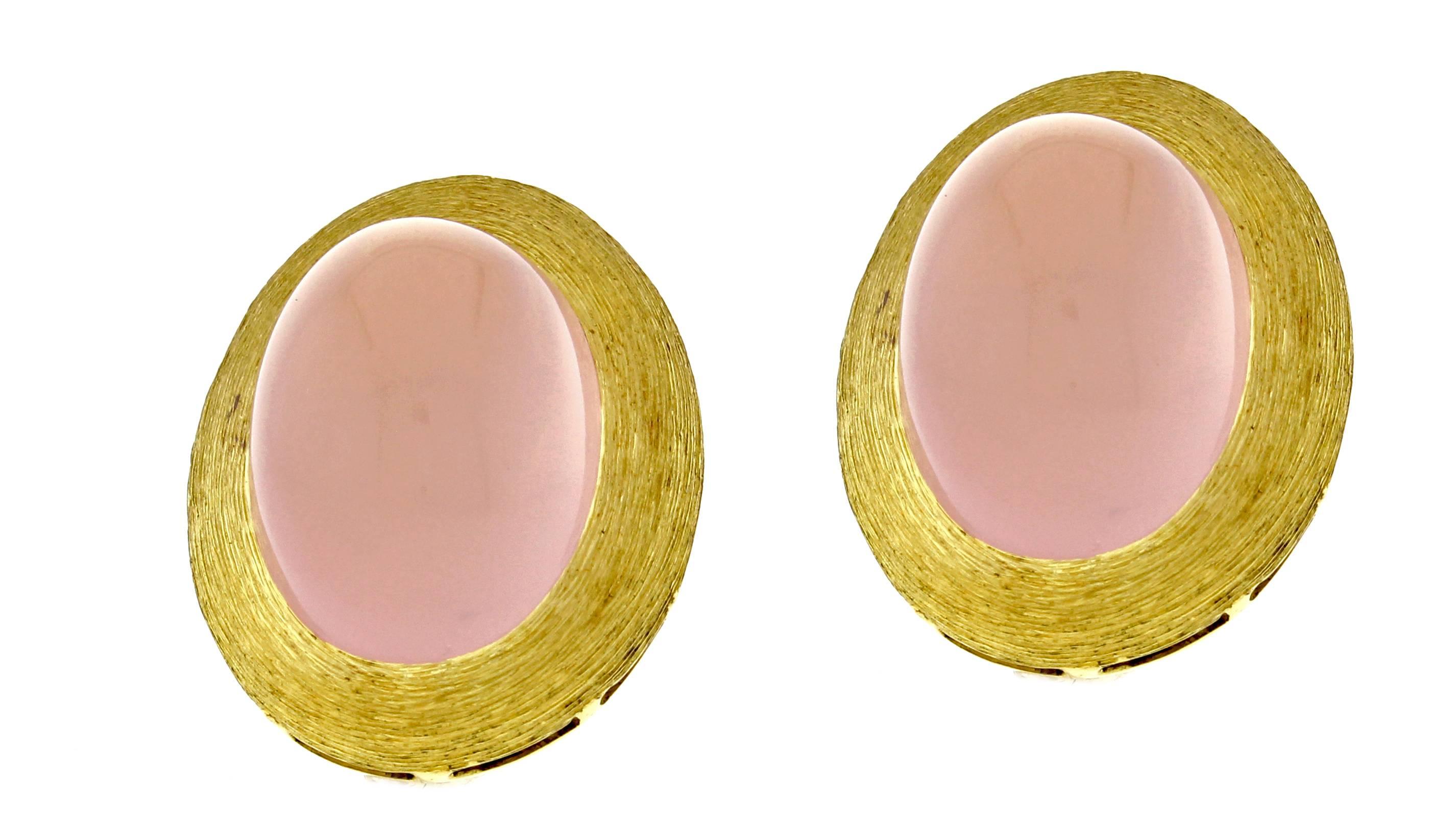 From acclaimed designer Henry Dunay a pair rose quartz earrings. The earring feature a 18*12mm cabochon rose quartz set in an 18 karat gold frame with Dunay's distinctive Saba finish. The earrings measure 25*18mm 