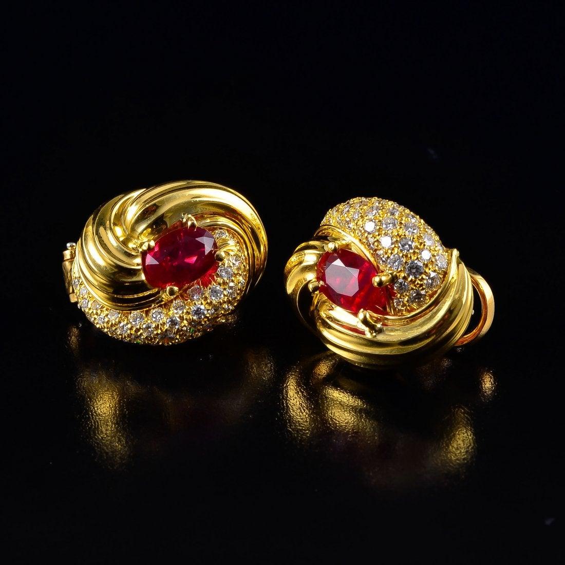 A stunning pair of vintage 1980's 18k gold, ruby and diamond earrings by Henry Dunay, 

The earrings of knot form, with a well matched pair of bold and bright Burmese rubies at the center - approximately 3.45ct total. 
One side of each earring pave