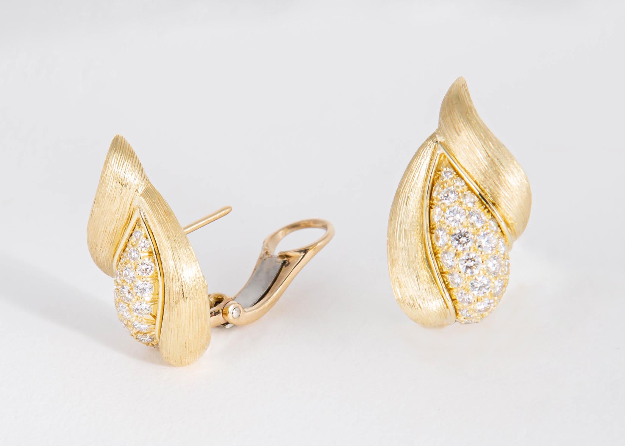 Henry Dunay's Sabi collection features completely hand engraved and finished 18k gold. He has combined brilliant cut diamonds in this soft flattering shaped design that can go from daytime to evening. Approximately 1 inch in length. 1.54 carats
