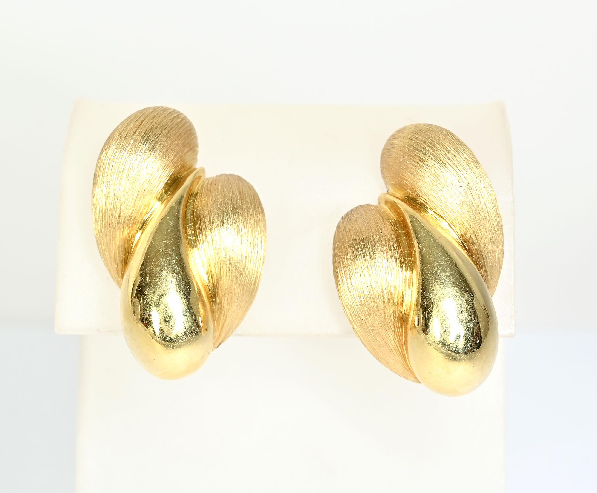 Henry Dunay combined two of his favorite finishes on these eighteen karat gold earrings. The center lobe is a gloss finish with his sabi, or brushed finish, on either side, The earrings have clip backs that can be converted  to posts. The earrings