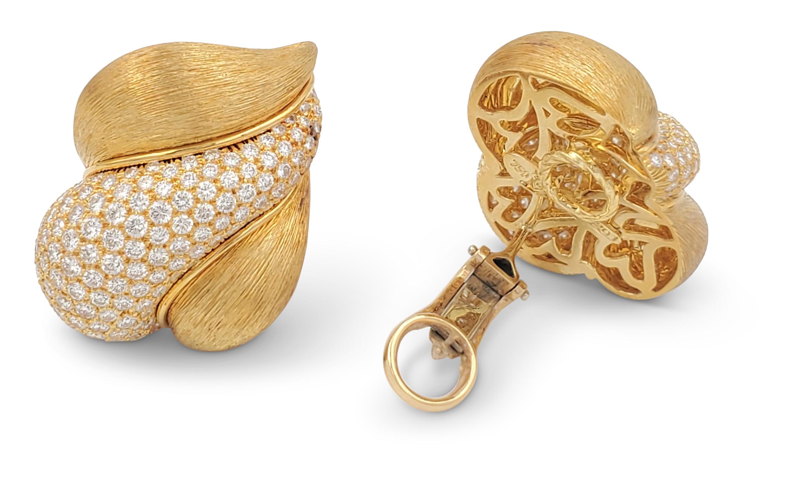 Striking vintage Henry Dunay earrings crafted in brushed 18 karat yellow gold and pave set with an estimated 6.65 carats of high quality (E-F color, VS clarity) round brilliant cut diamonds. Signed Dunay, maker's mark for Henry Dunay, 18K, 750. Clip