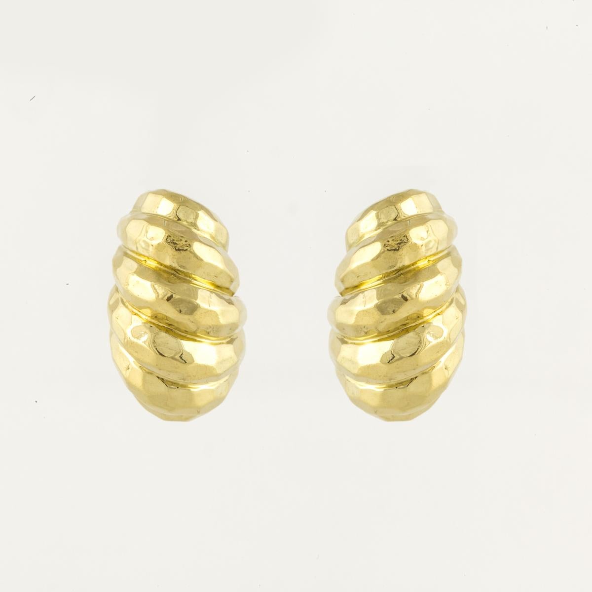 Henry Dunay earrings in a modified shrimp style composed of hammered 18K yellow gold,  They measure 1 3/16 inches long by 5/8 inches wide and 1/2 inch deep.  They are a clip style.