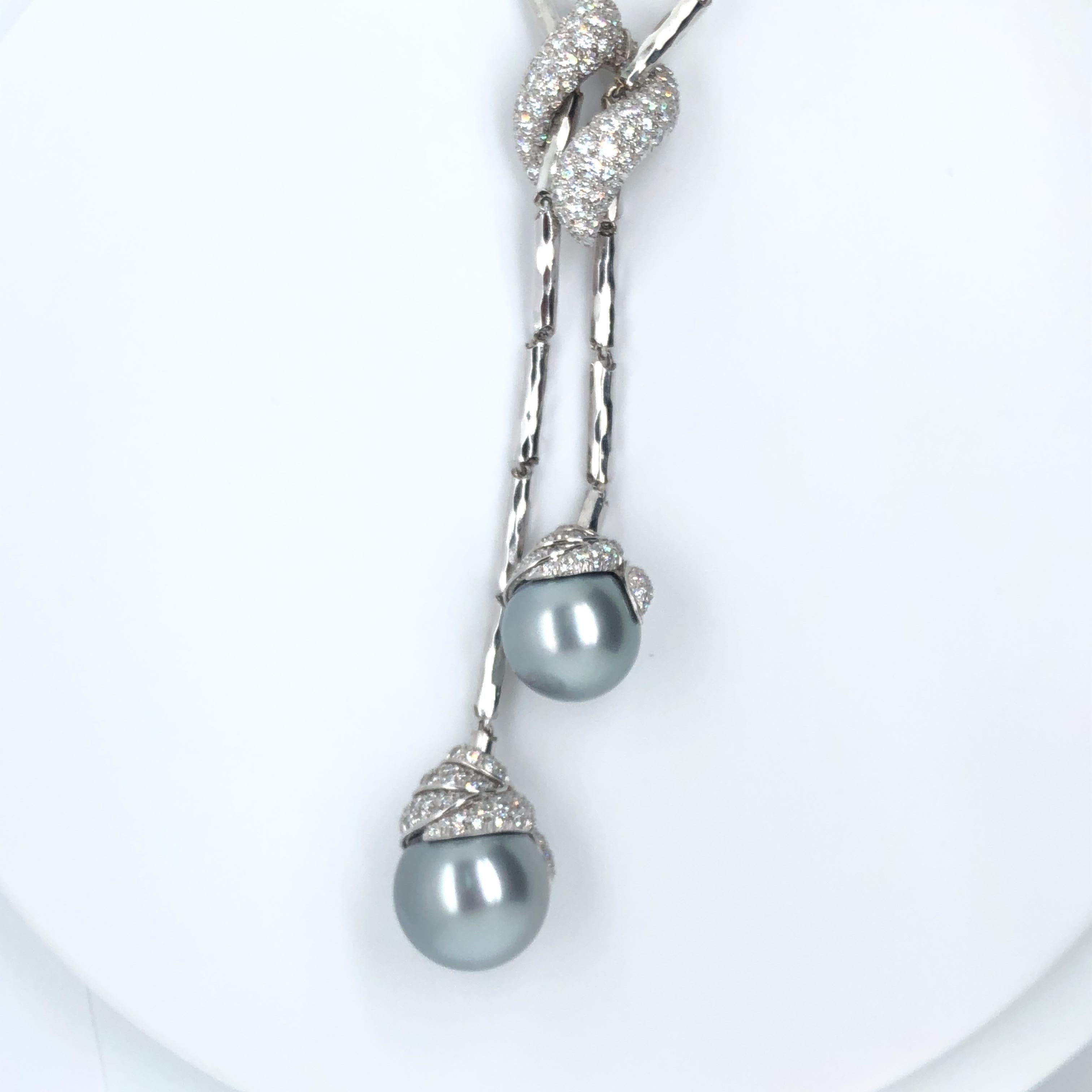 This elegant, ~18.5 inch 'hammered' platinum necklace by acclaimed designer Henry Dunay drapes beautifully when worn, centered by two Tahitian pearls that dangle with designed asymmetry.  This necklace - which essentially received its own entire