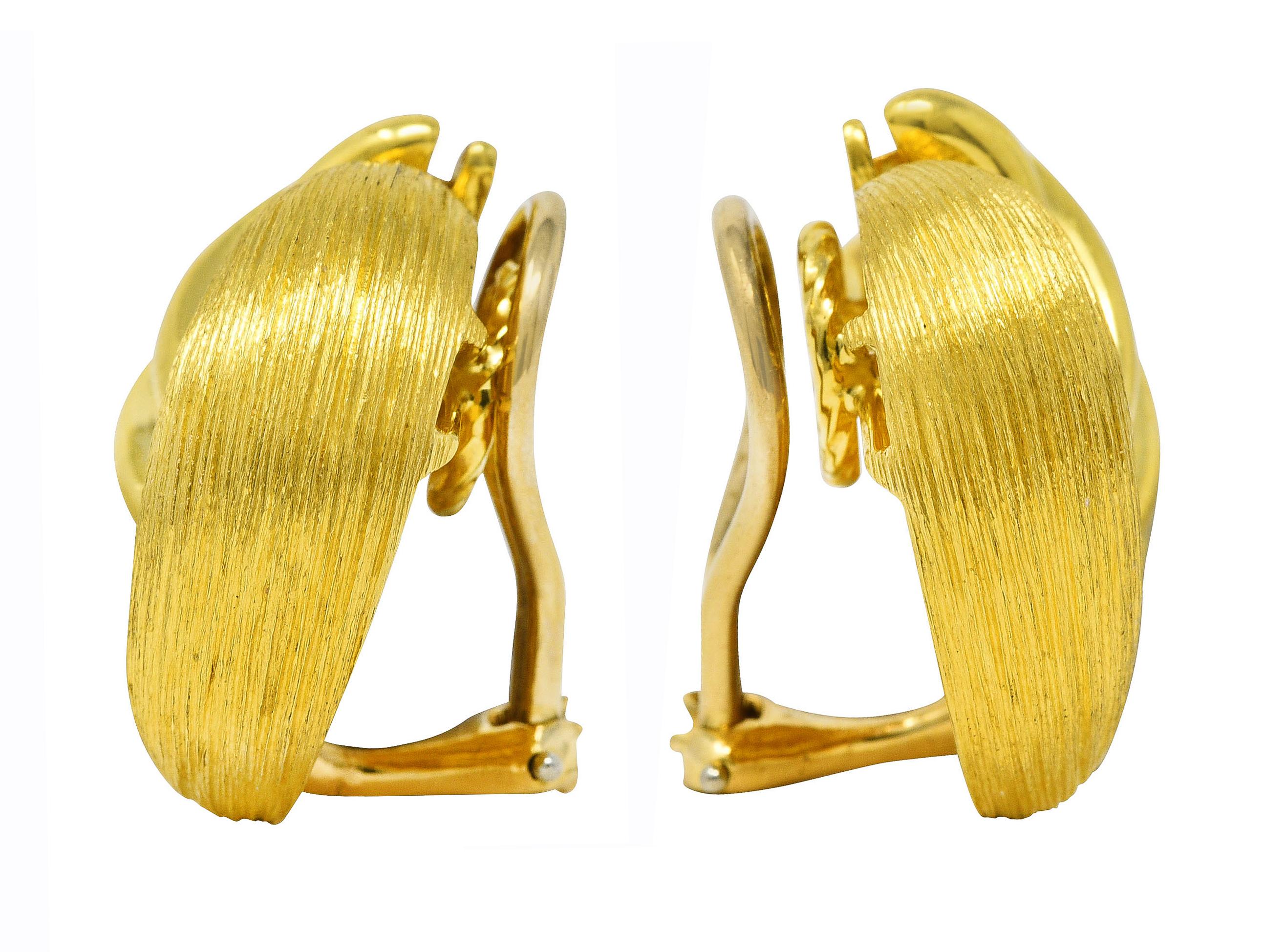 Ear-clip earrings are designed as two contrasting gold forms swirling together

One from is high polished and deeply grooved while the other is brushed gold

Completed by hinged omega backs

Stamped 18k and 750 for 18 karat gold

Numbered and signed