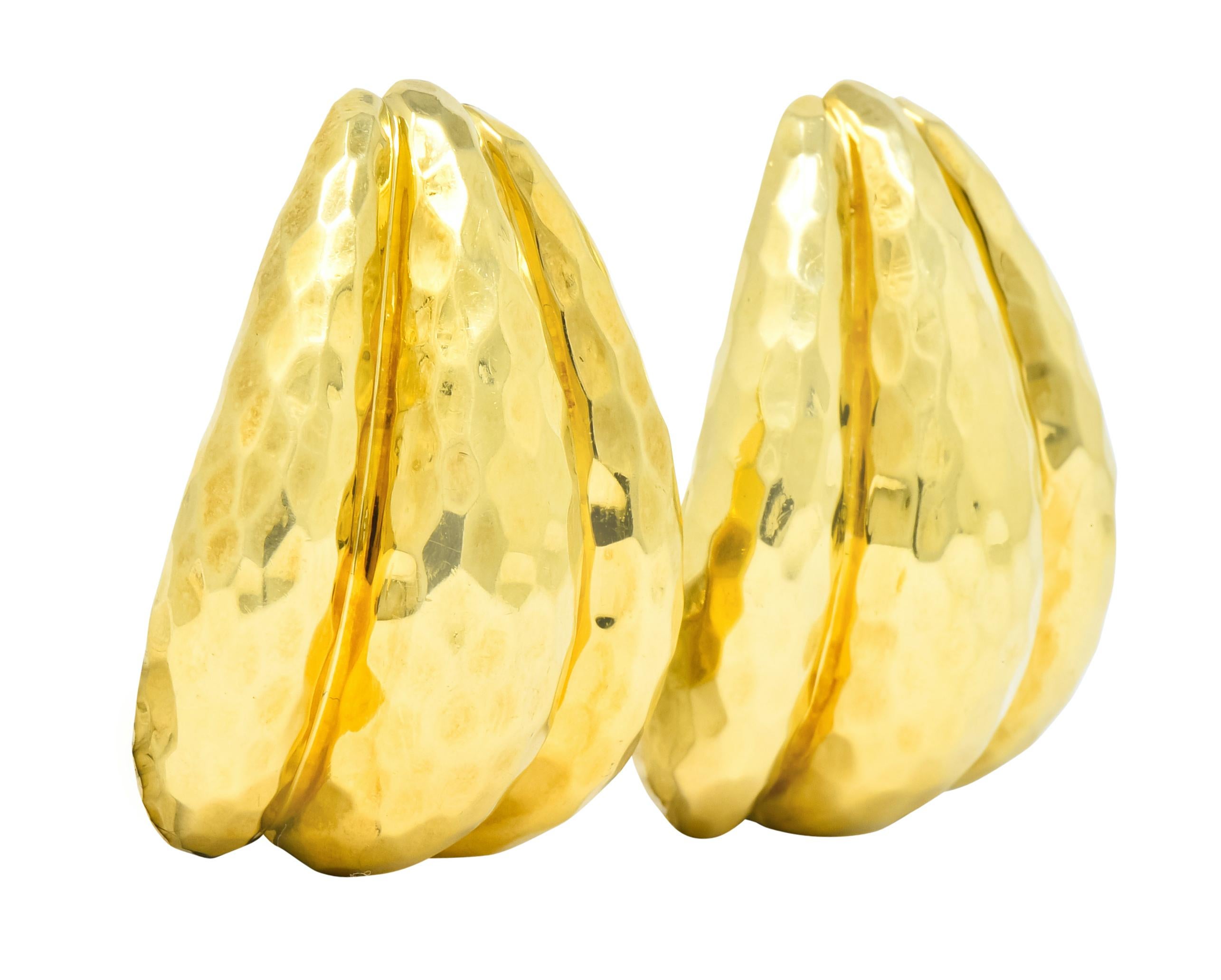 Large, hollow, earrings designed as three segments of polished gold with a hammered texture throughout 

Completed by posts and hinged omega backs 

Signed Dunay for Henry Dunay 

Stamped 750 for 18 karat gold 

Circa 1980's 

Measures: 1 7/8 x 1