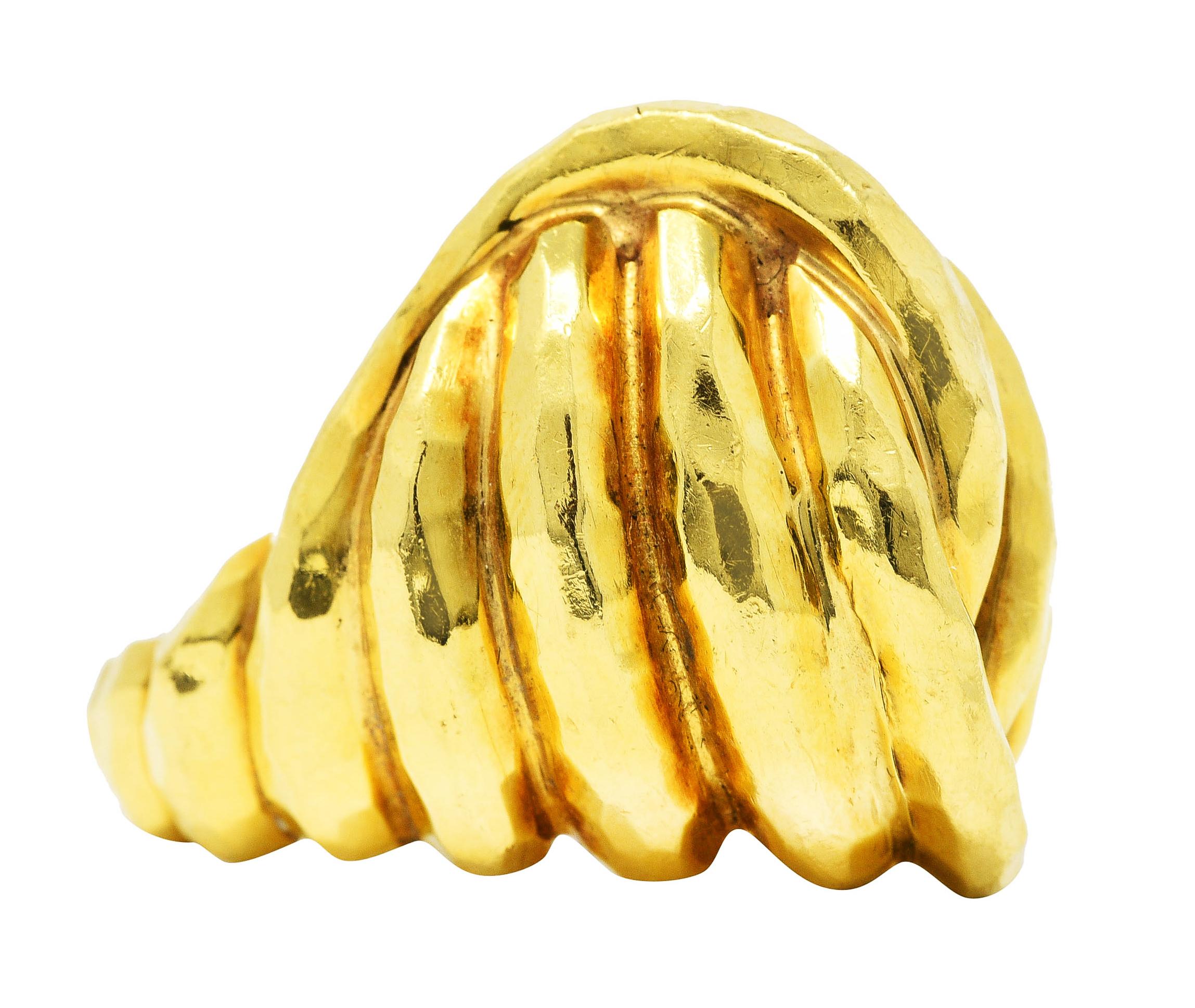 Ring is designed as domed form with grooved segments twisted into knot

Featuring hammered gold texture

Stamped 18k for 18 karat gold

With maker's mark for Henry Dunay

Circa: 1980's - from the Cynnabar collection

Ring size: 6 1/4 and not
