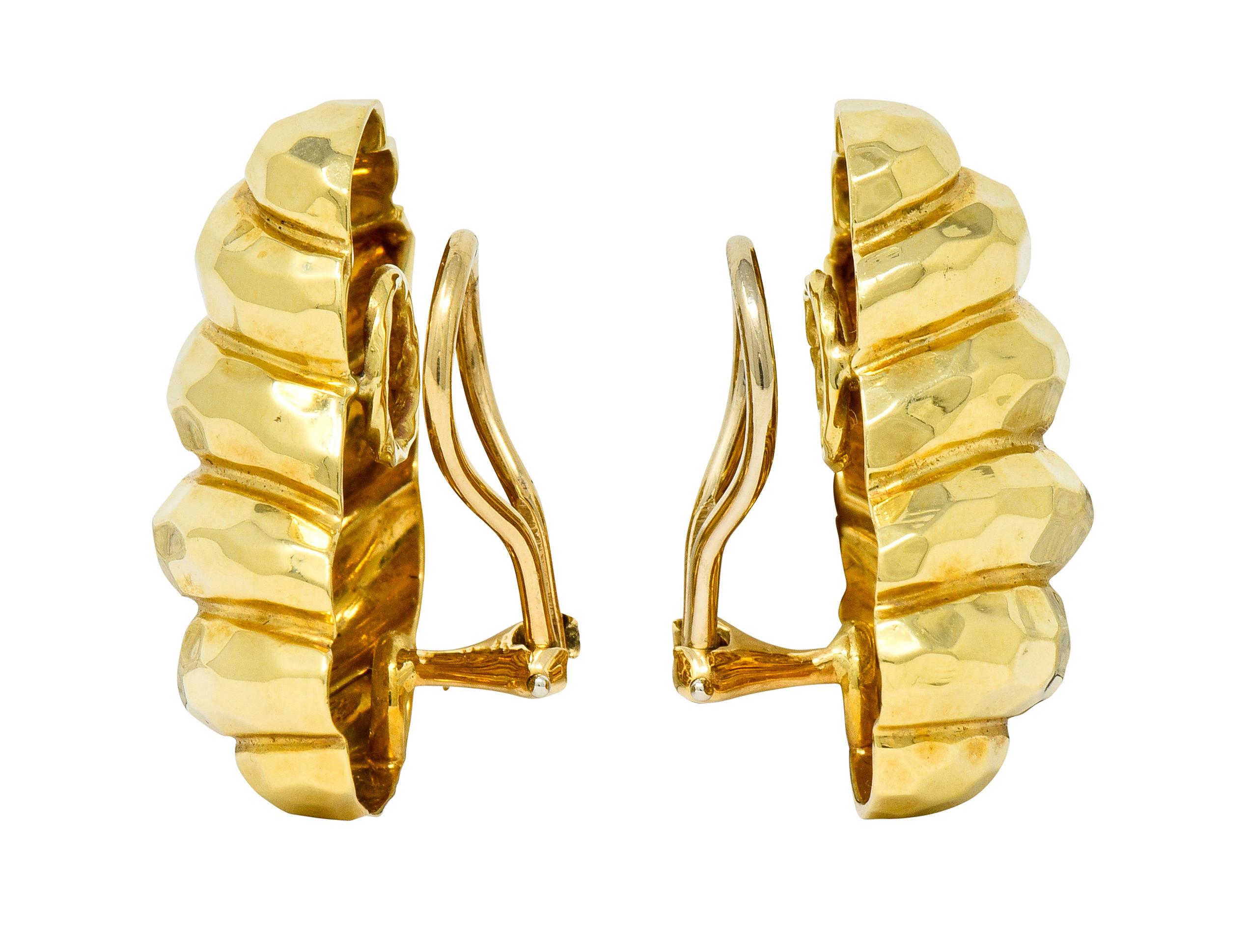 Ear-clip earrings designed a domed form twisted into several polished gold segments

Featuring a hammered finish

Completed by hinged omega backs

One earring is signed Dunay and stamped 18K for 18 karat gold

Circa: 1980s

Measures: 13/16 x 1 3/16