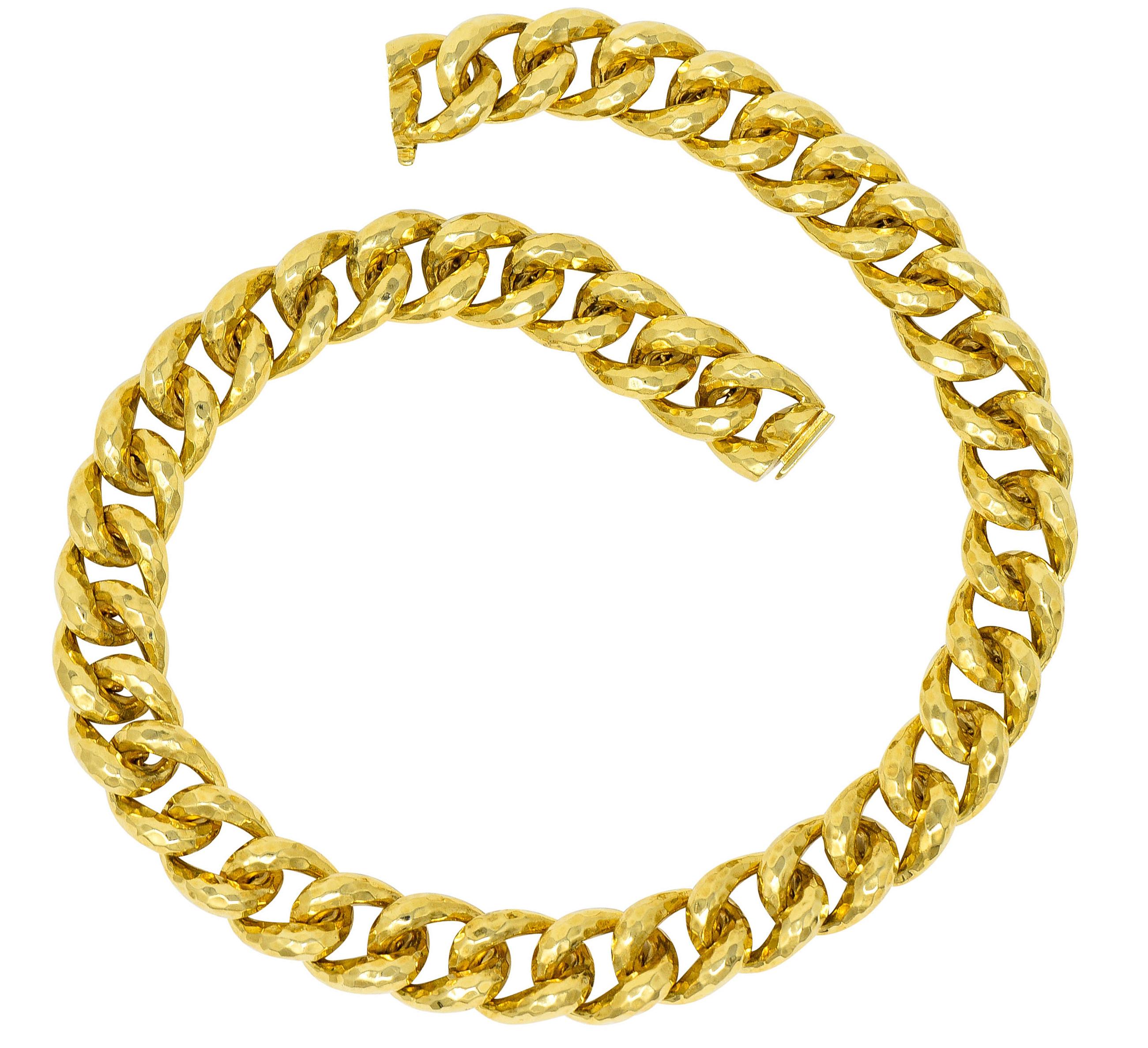 Designed as a chain necklace with substantial curbed links

Featuring a brightly polished hammered finish

Completed by a concealed clasp with a fold over safety

Stamped 18K and 750 for 18 karat gold

Fully signed Henry Dunay with maker's