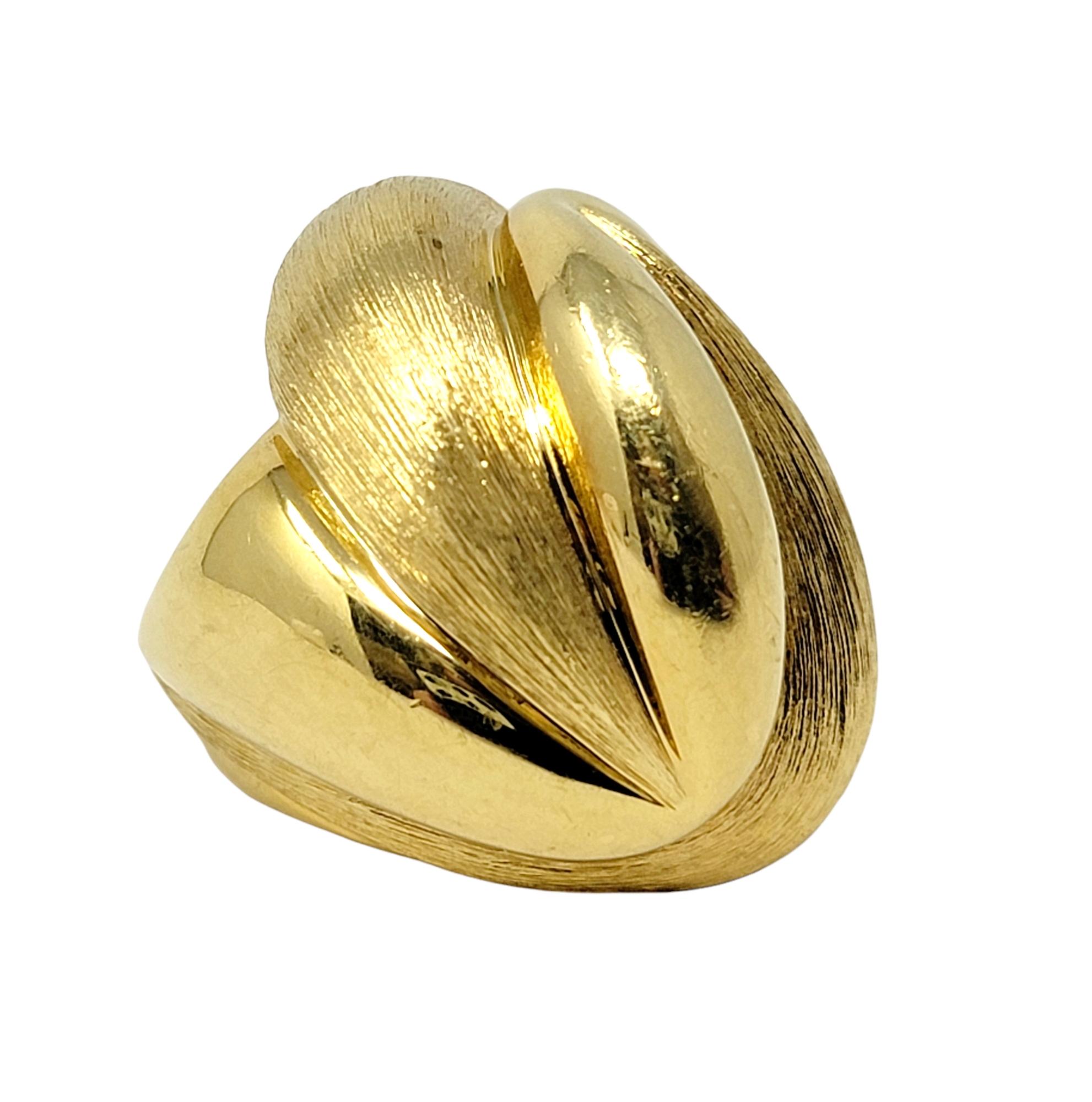 Ring size: 6.5

Uniquely textured 18 karat yellow gold cocktail ring by American jewelry designer, Henry Dunay. Bold in both size and design, this substantial ring offers stunning sophistication without being over the top, while the sleek curves and