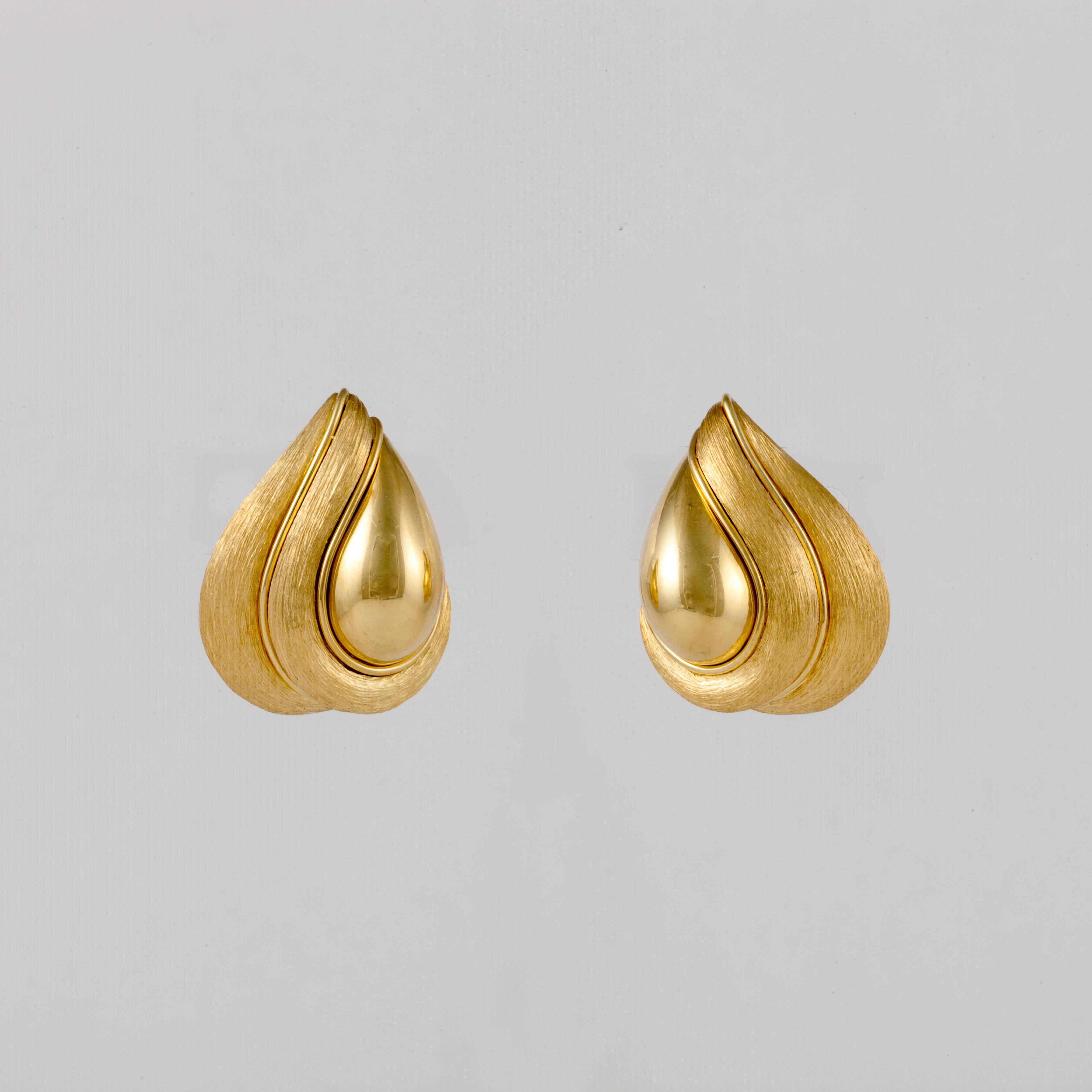 Henry Dunay earrings composed of 18K yellow gold with both the Sabi and high polish finishes.  They measure 1 1/8 inches long and 7/8 inch wide.  They are clip style earrings.
