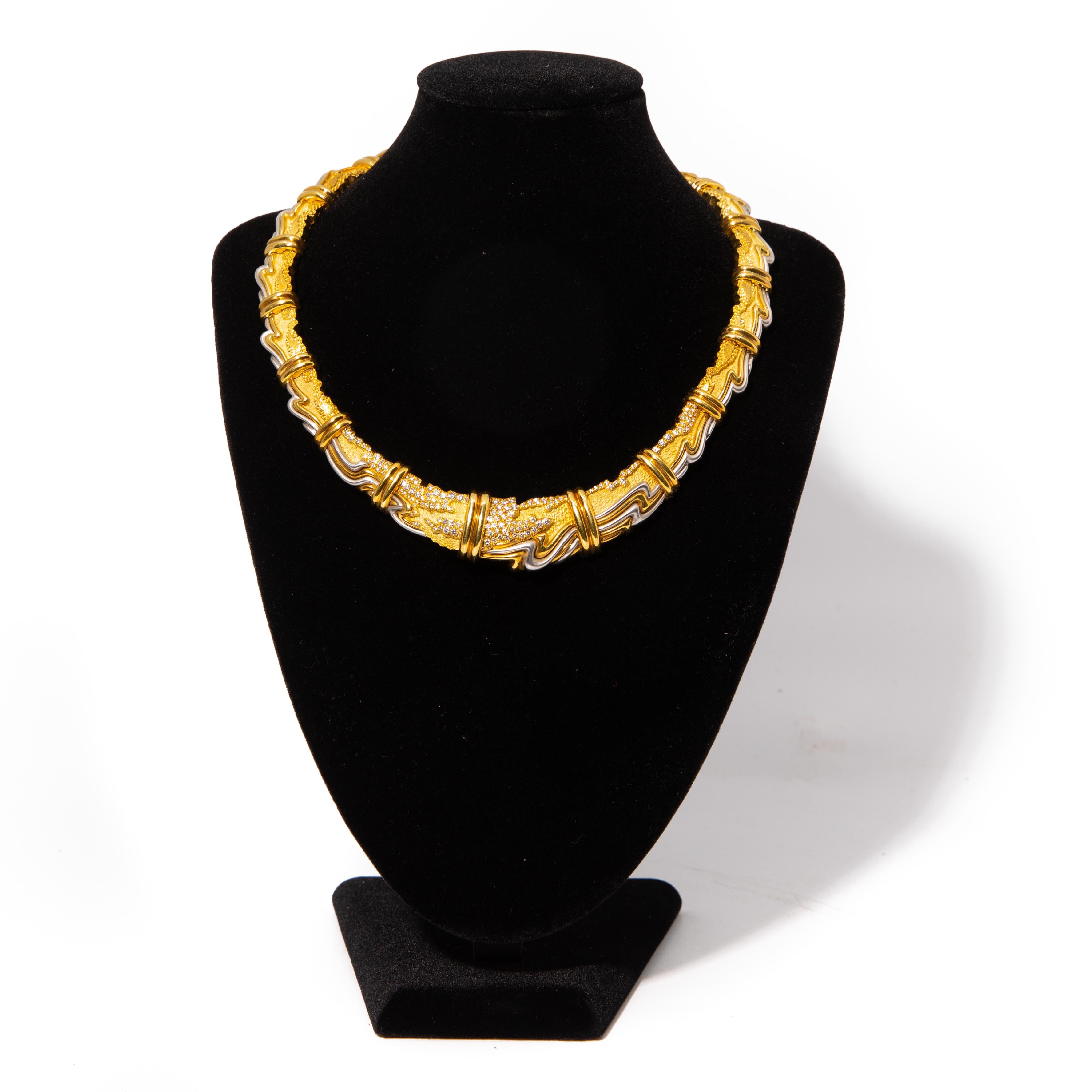 HENRY DUNAY, YELLOW GOLD, PLATINUM AND DIAMOND COLLAR NECKLACE. Consisting of textured matte and high polish graduating links, with organic yellow gold and platinum detail containing numerous round brilliant cut diamonds weighing approximately 1.65